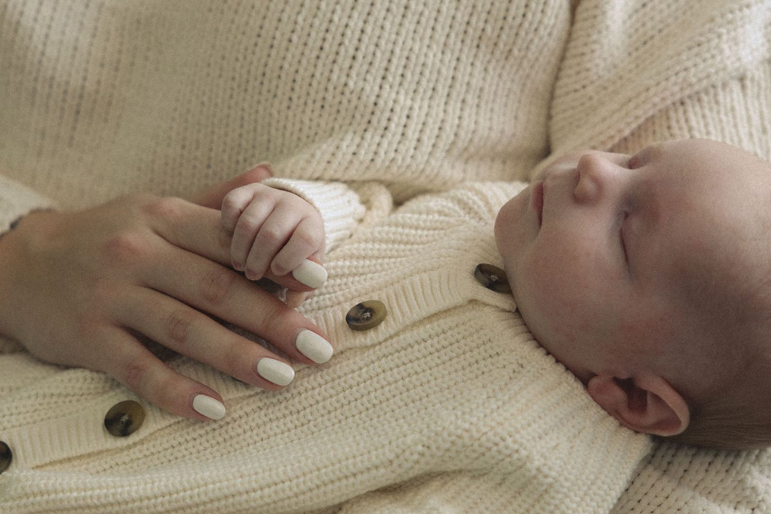 A series of connected images showing a baby lying on a cream-colored knit blanket while being examined with a stethoscope.
