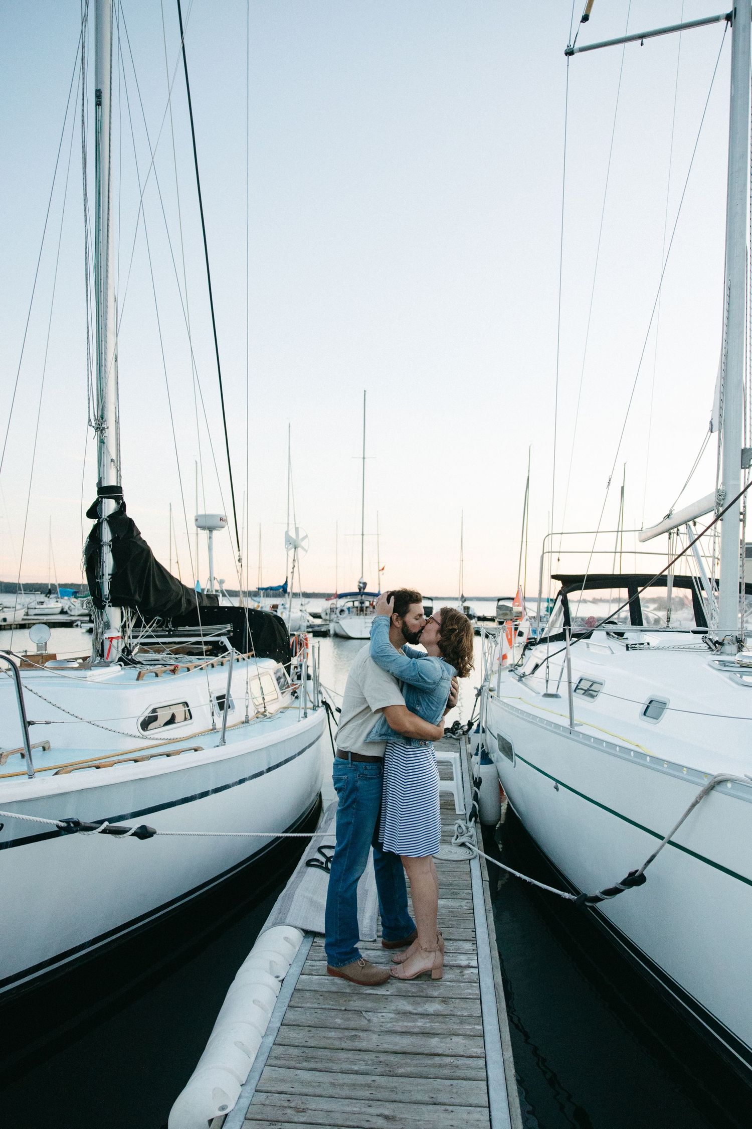 A series of photos showing sailboats docked at a marina during sunset.