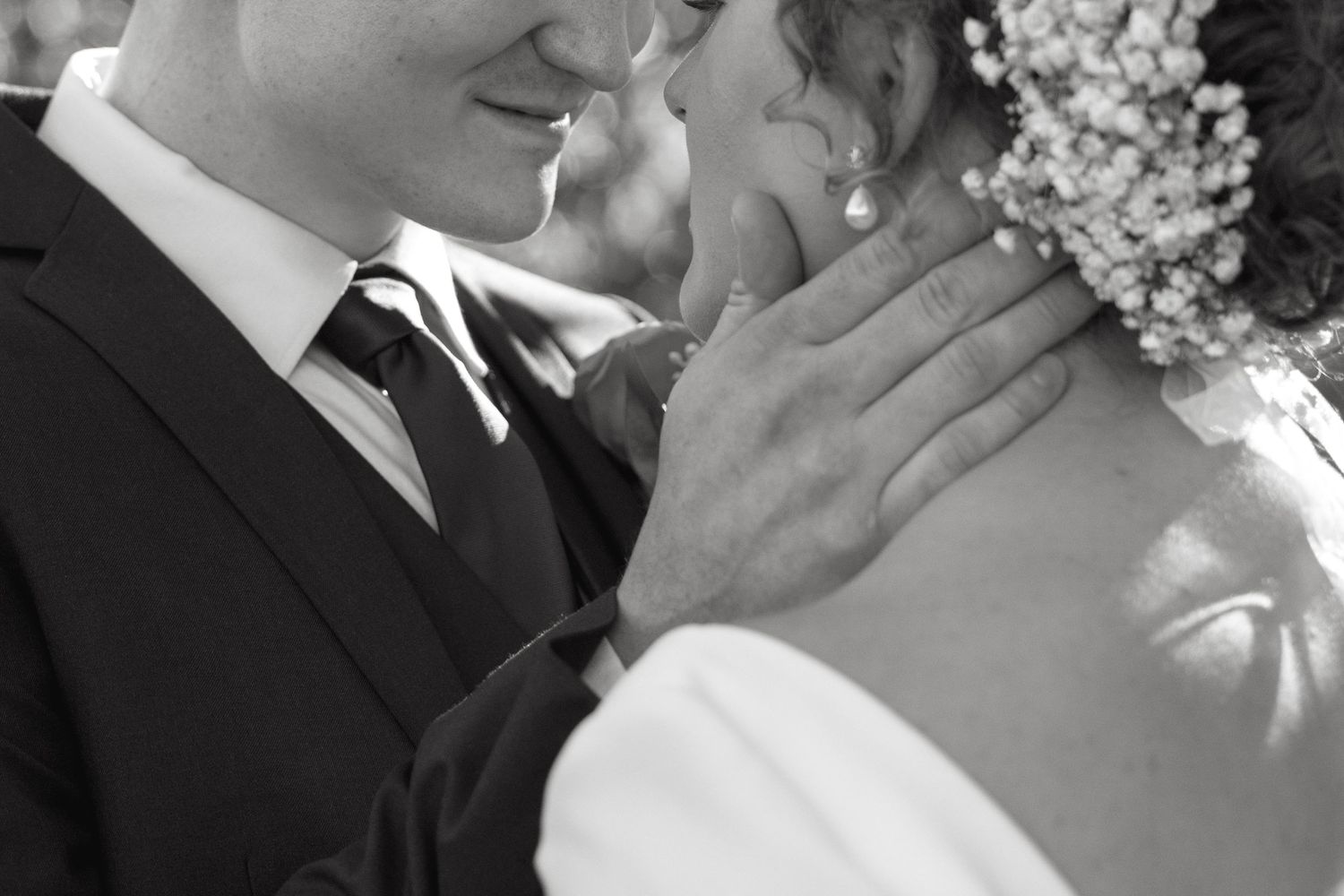 An intimate black and white wedding portrait showing tender expressions.