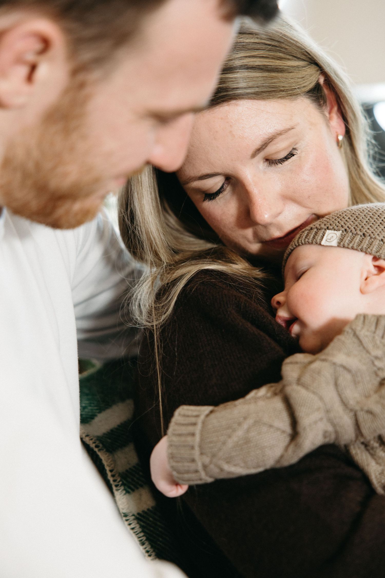 Close-up shots of tender family moments in a cozy indoor setting.