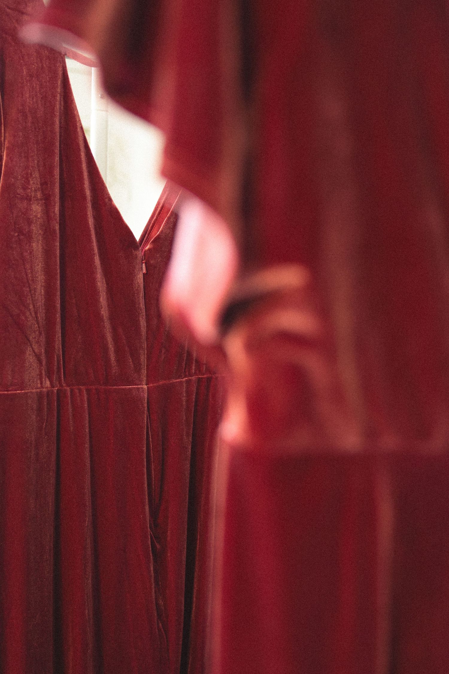 Close-up of deep red velvet fabric with dramatic lighting and shadows.