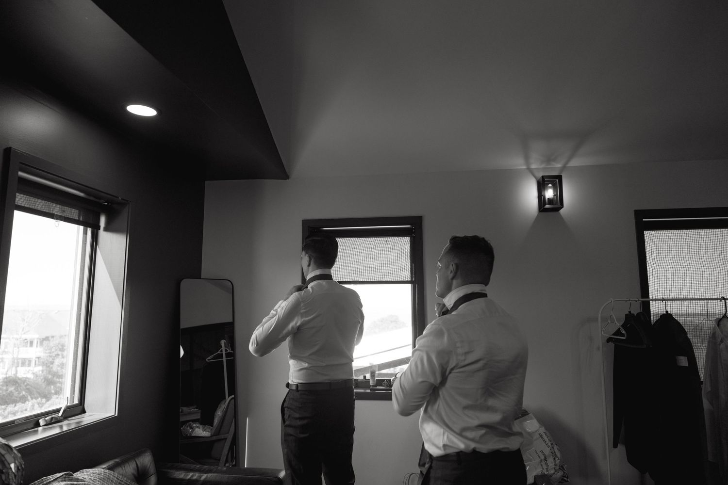 Wedding preparations in a room with natural light streaming through windows.