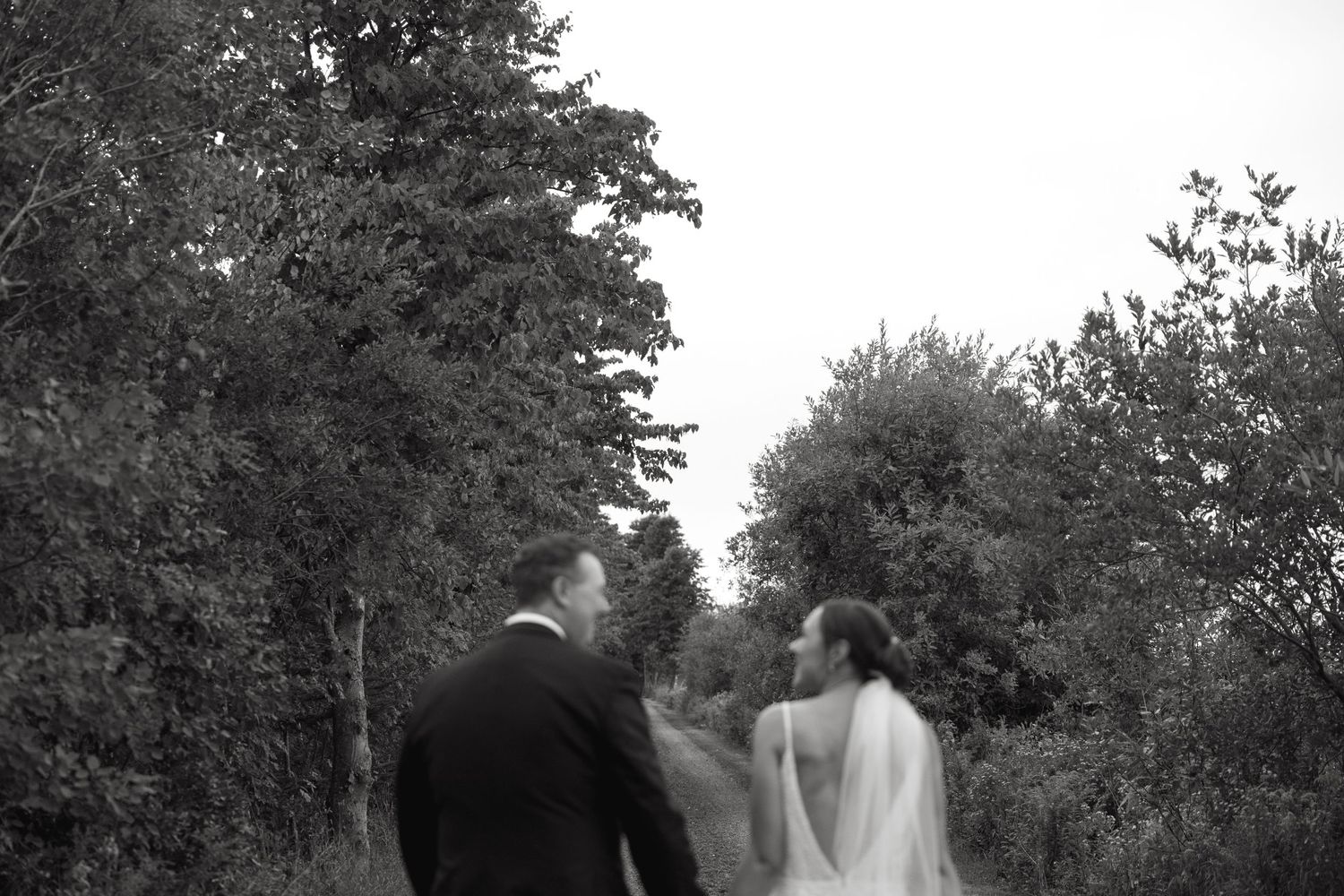 Wedding portraits taken among trees in natural outdoor setting.