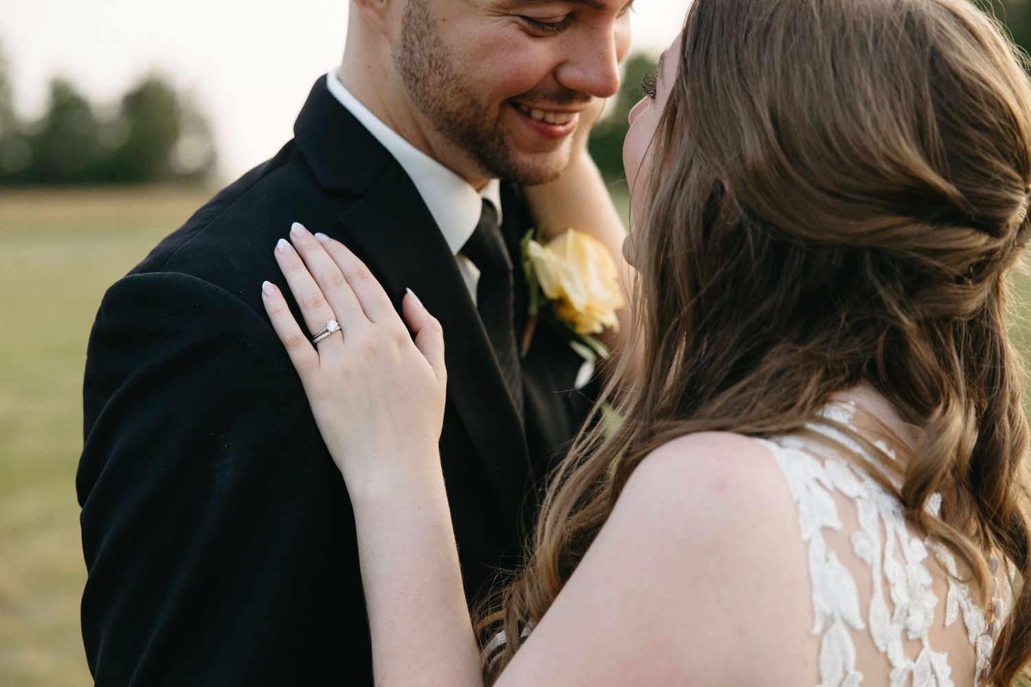 Close-up romantic moment between newlyweds during outdoor wedding photoshoot.