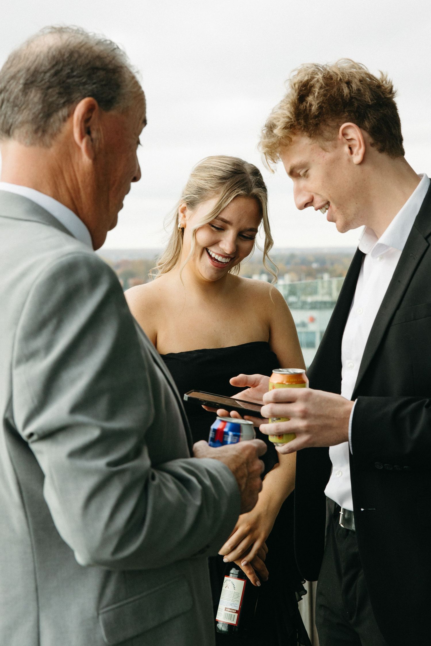 Candid moments of guests sharing drinks and laughter at a formal celebration.
