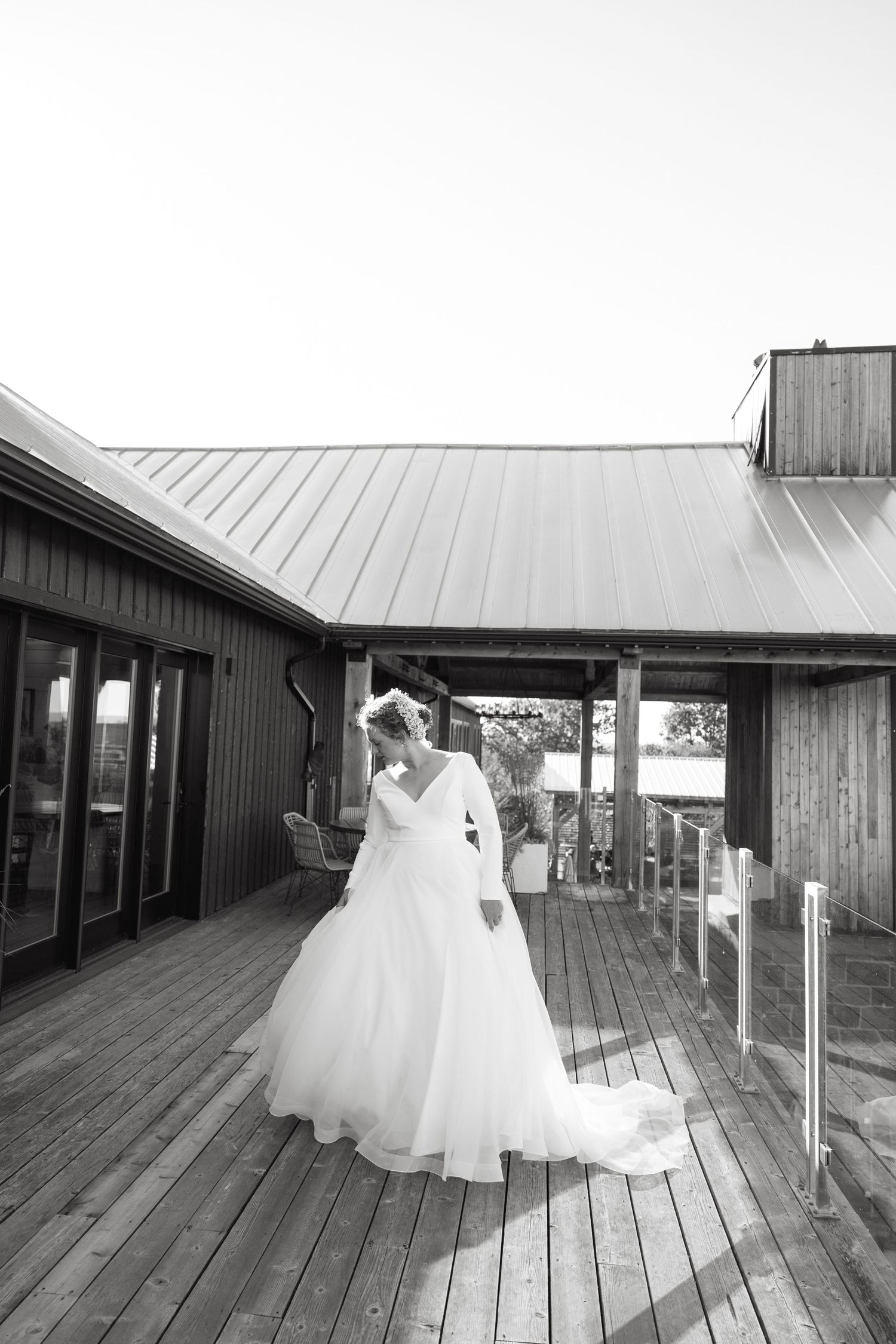 Black and white sequence showing flowing wedding dress movement across a wooden deck.