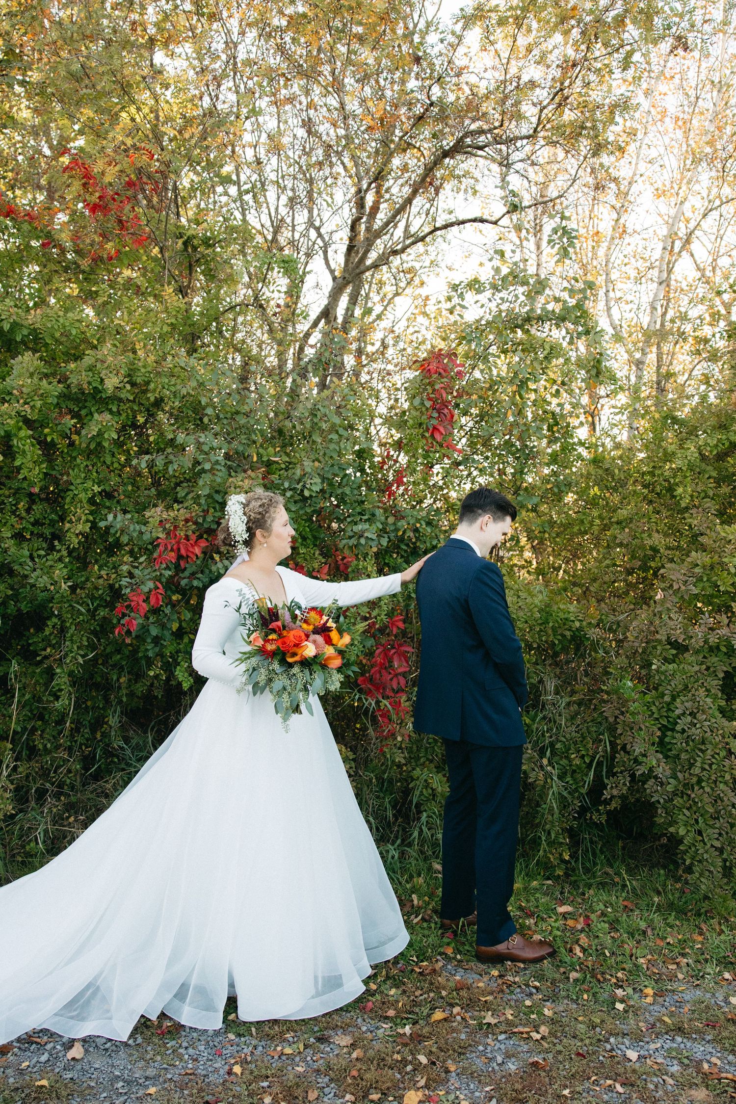 A playful wedding photo series showing a couple's first look reveal in a natural outdoor setting.