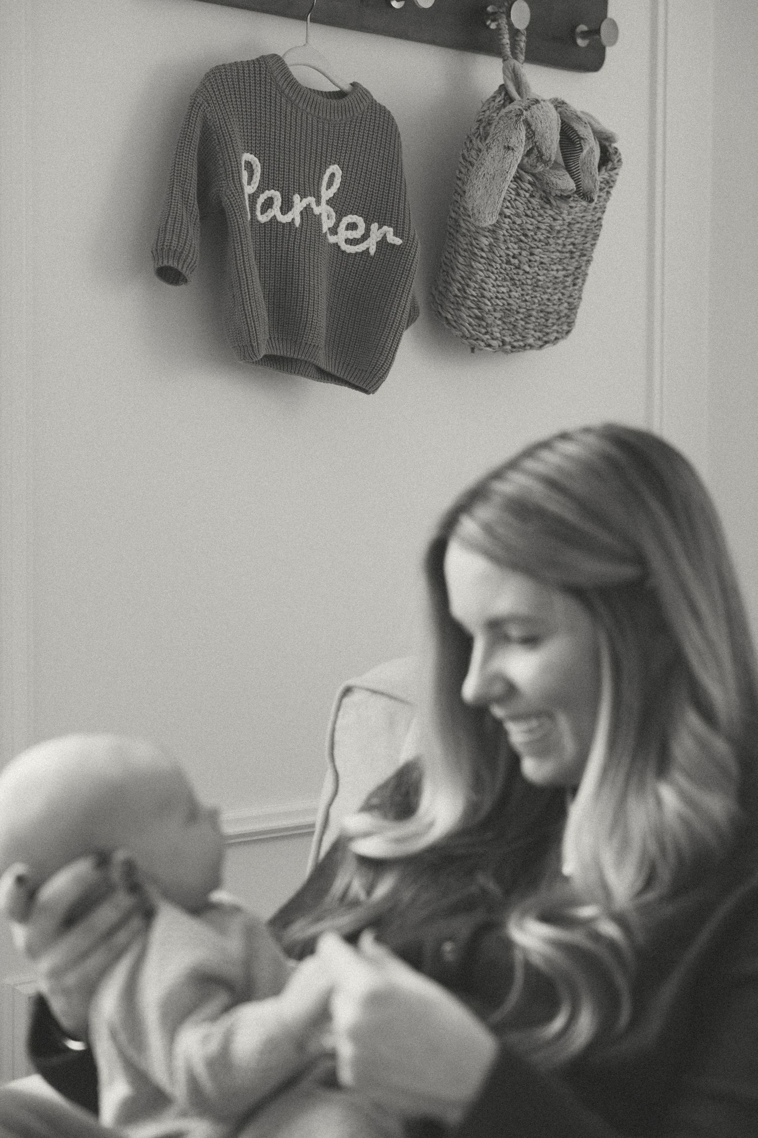 Black and white image of tender moment with newborn.