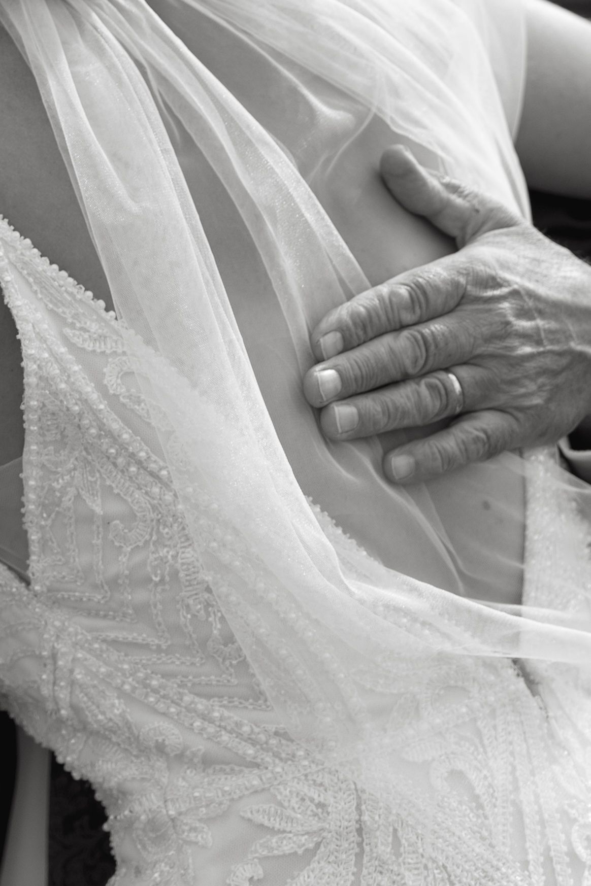 Detailed close-up shots of intricate beadwork and lace on a white wedding dress.