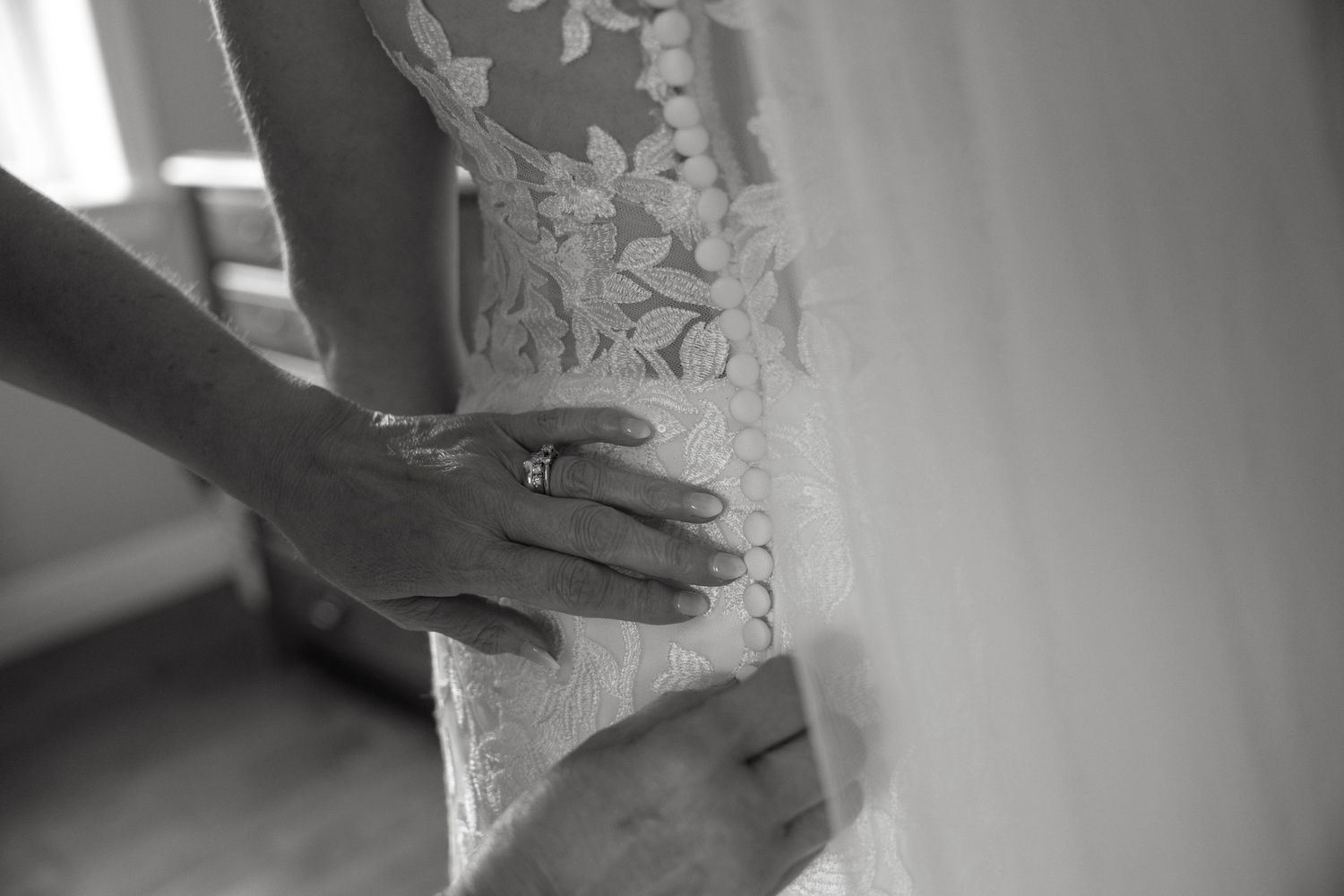 Close-up details of delicate white lace on formal attire.