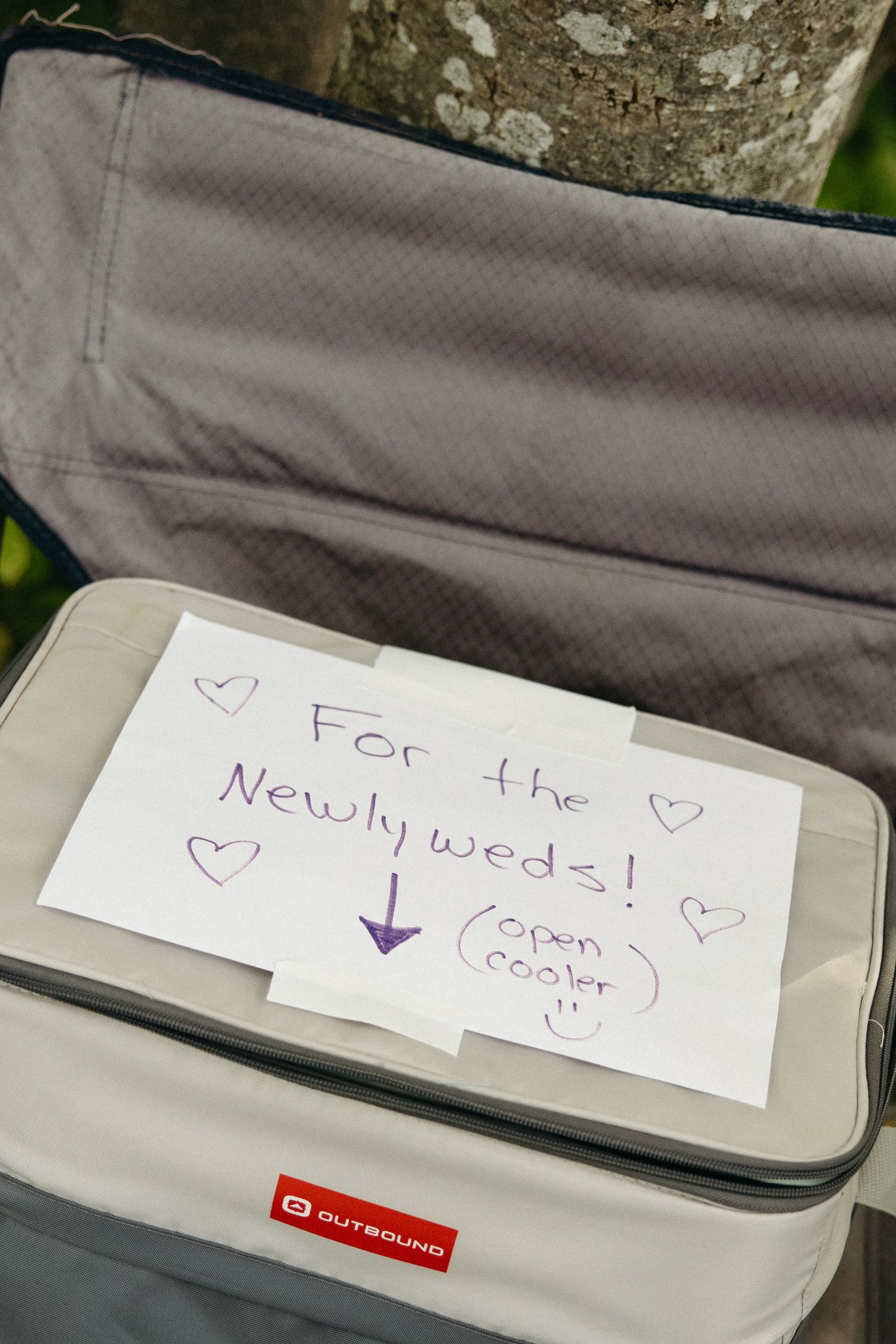 Handwritten note with hearts on a gray surface.