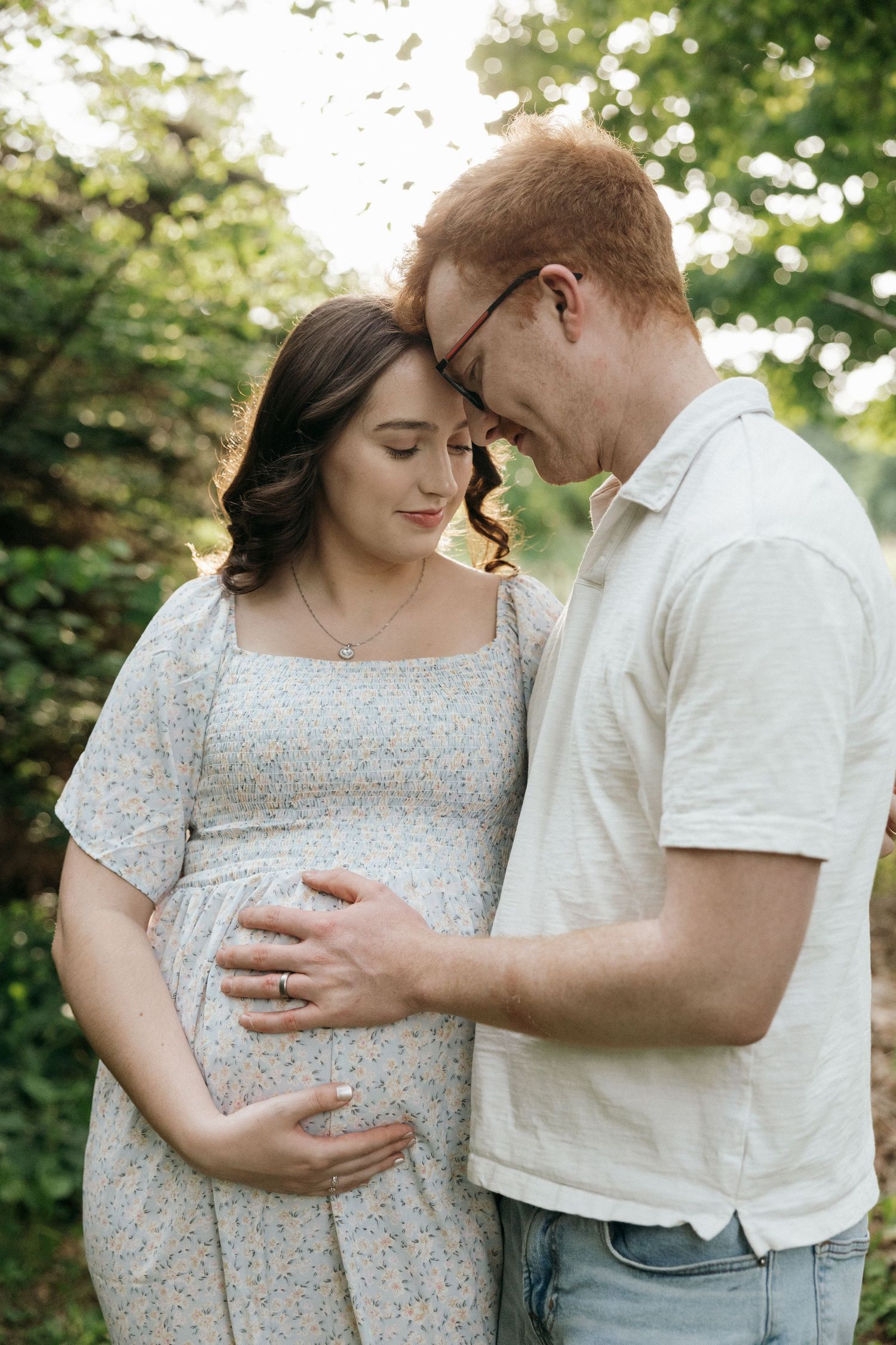 Intimate maternity portraits showing tender moments between expectant parents in nature.