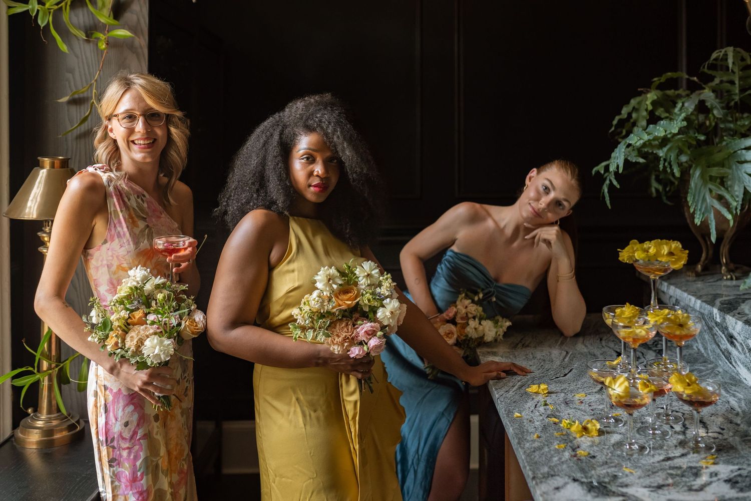 A series of candid moments at a social gathering with people in floral dresses sitting at a table with yellow flowers.