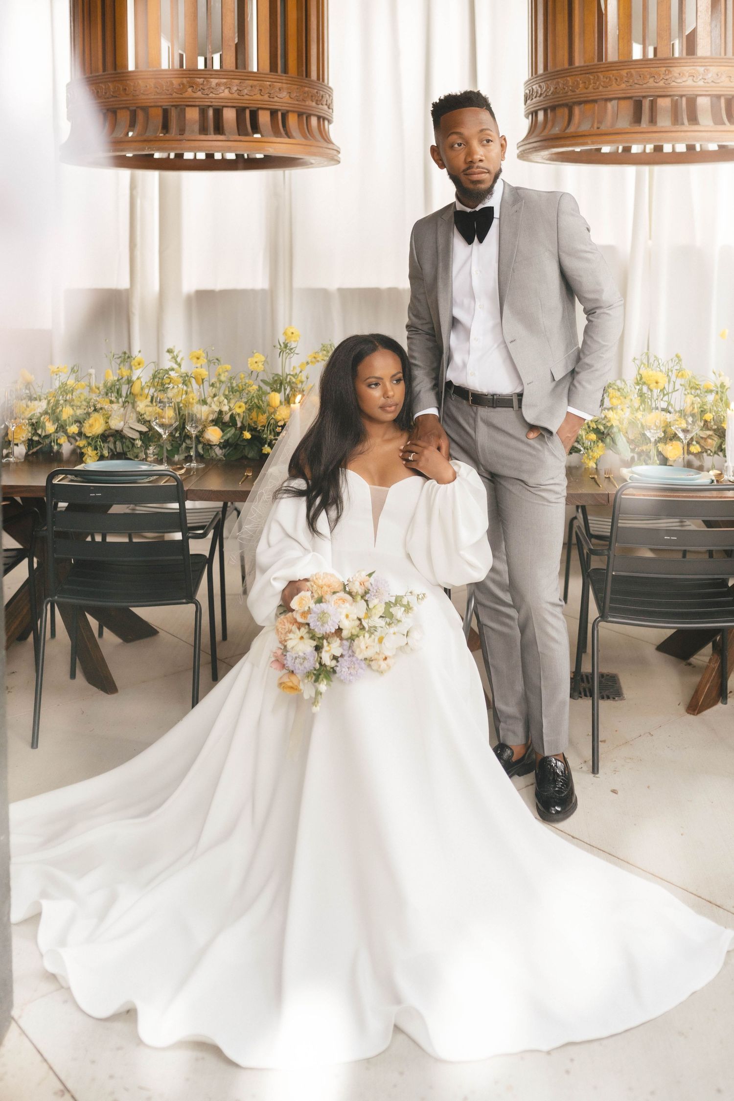 Wedding decor featuring white floral arrangements and elegant seating in a bright indoor venue.