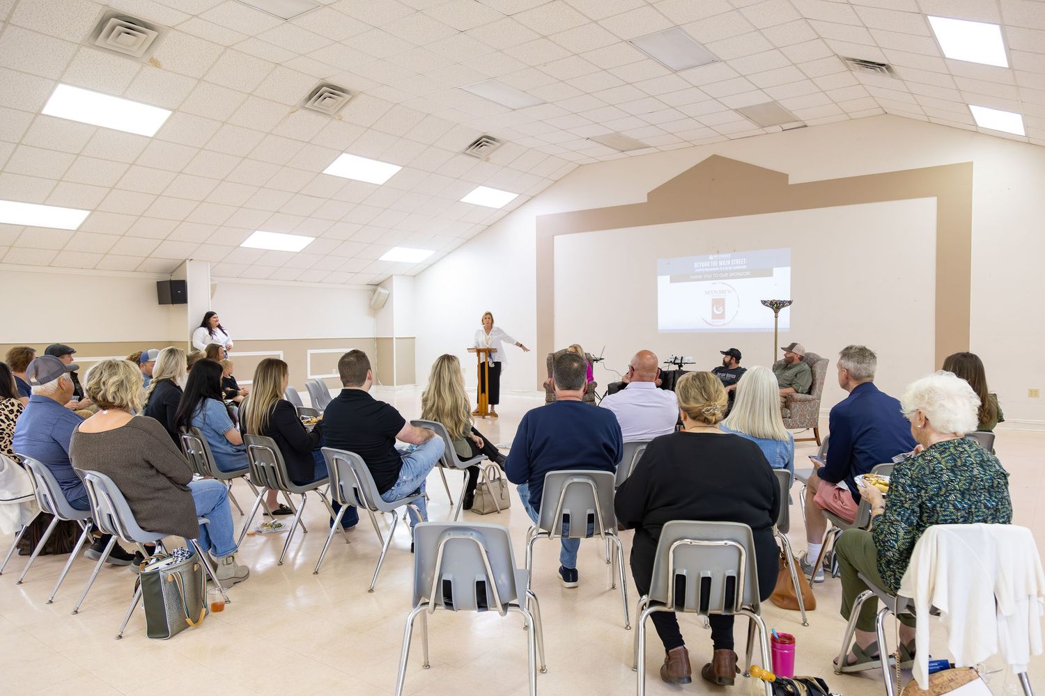 Community meeting with speaker addressing seated audience