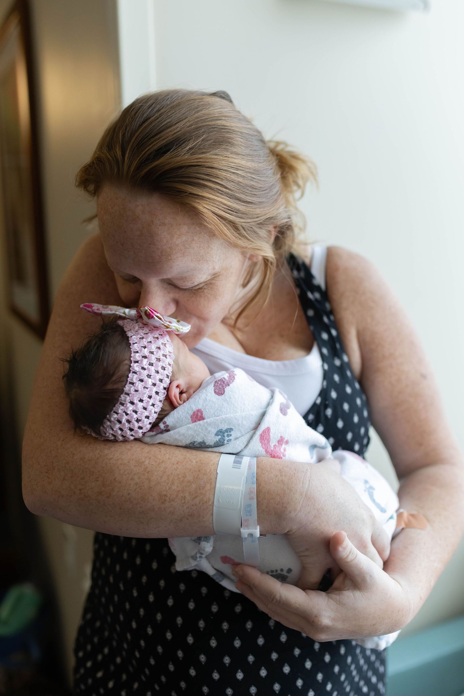Mother holding newborn during Fresh 48 hospital session