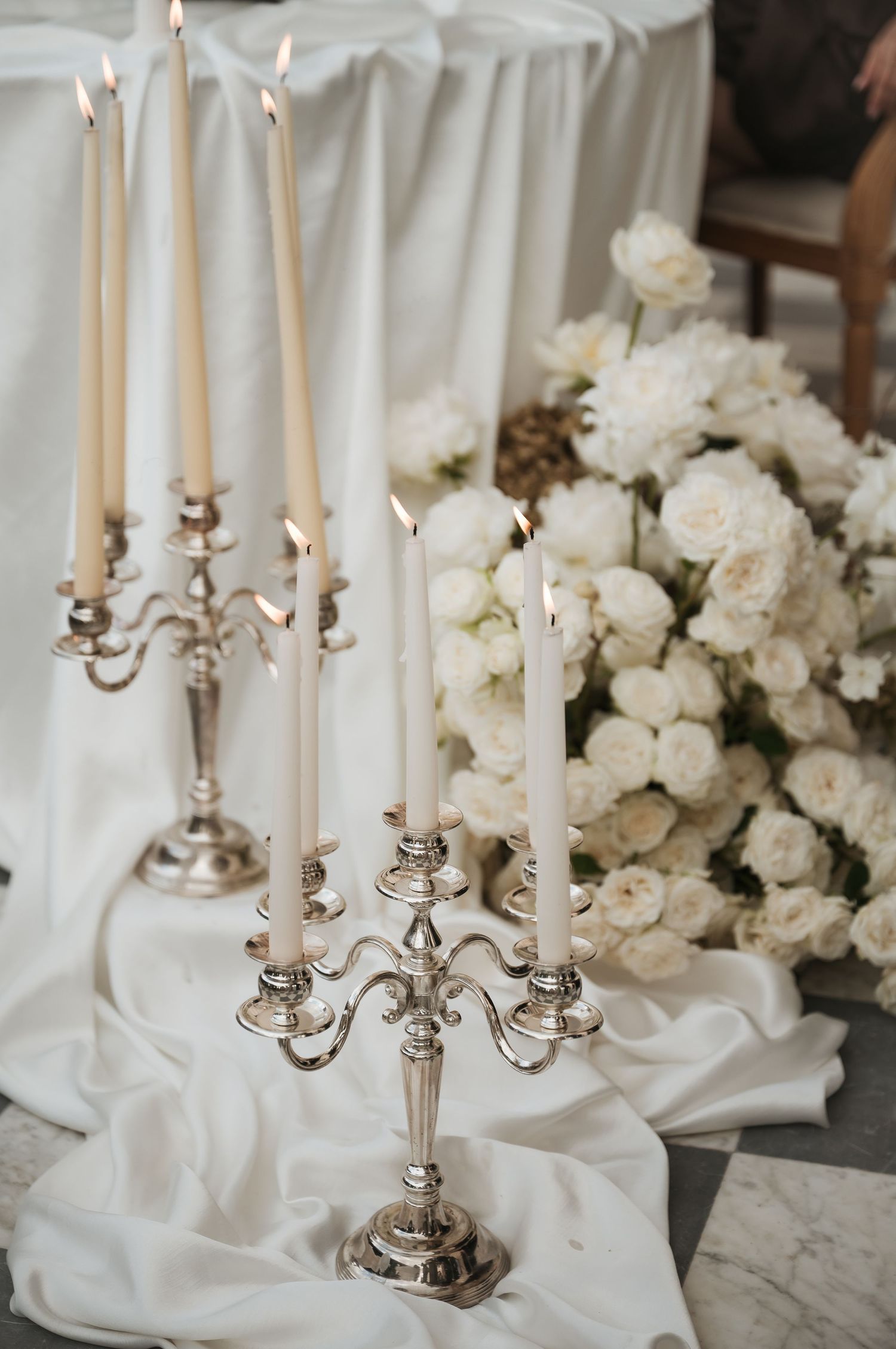 Tall silver candelabras with ivory candles and garden roses at Villa Astor reception