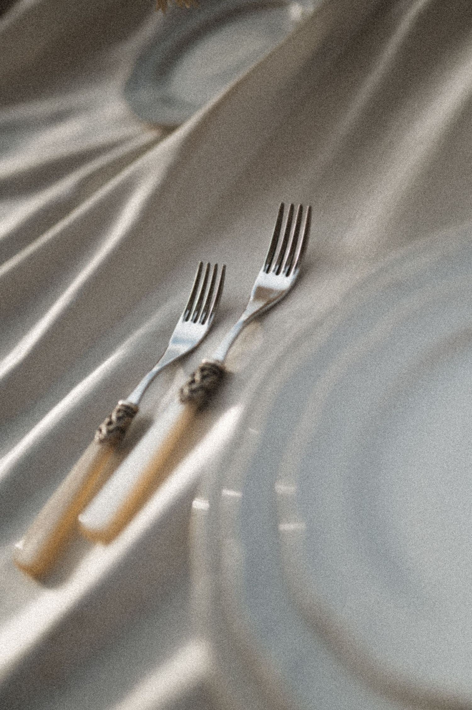 Refined table detail with silver cutlery on ivory satin at Villa Astor Sorrento