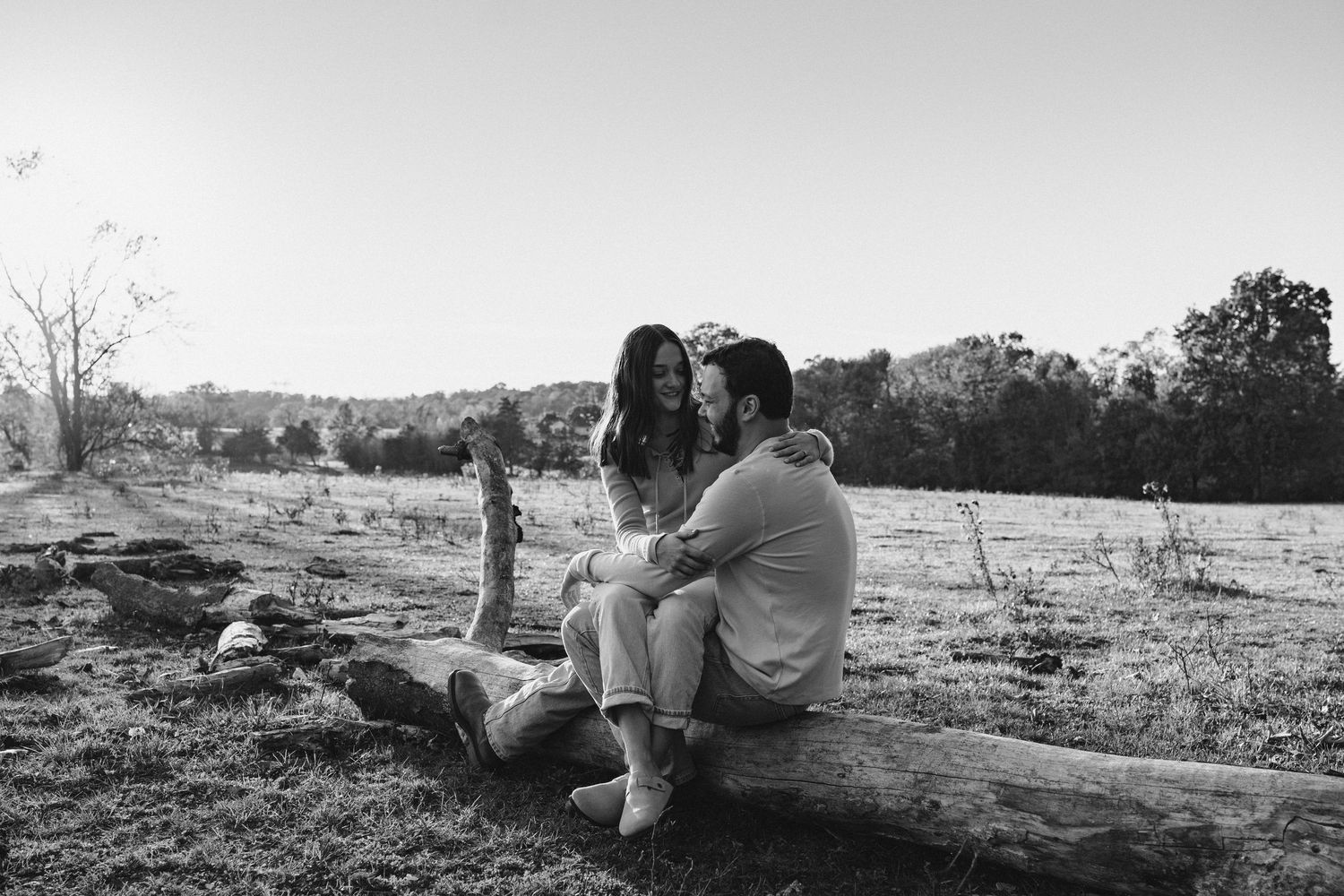 Black and white landscape photograph showing a a couple sitting for engagement photoshoot in Middletown, PA