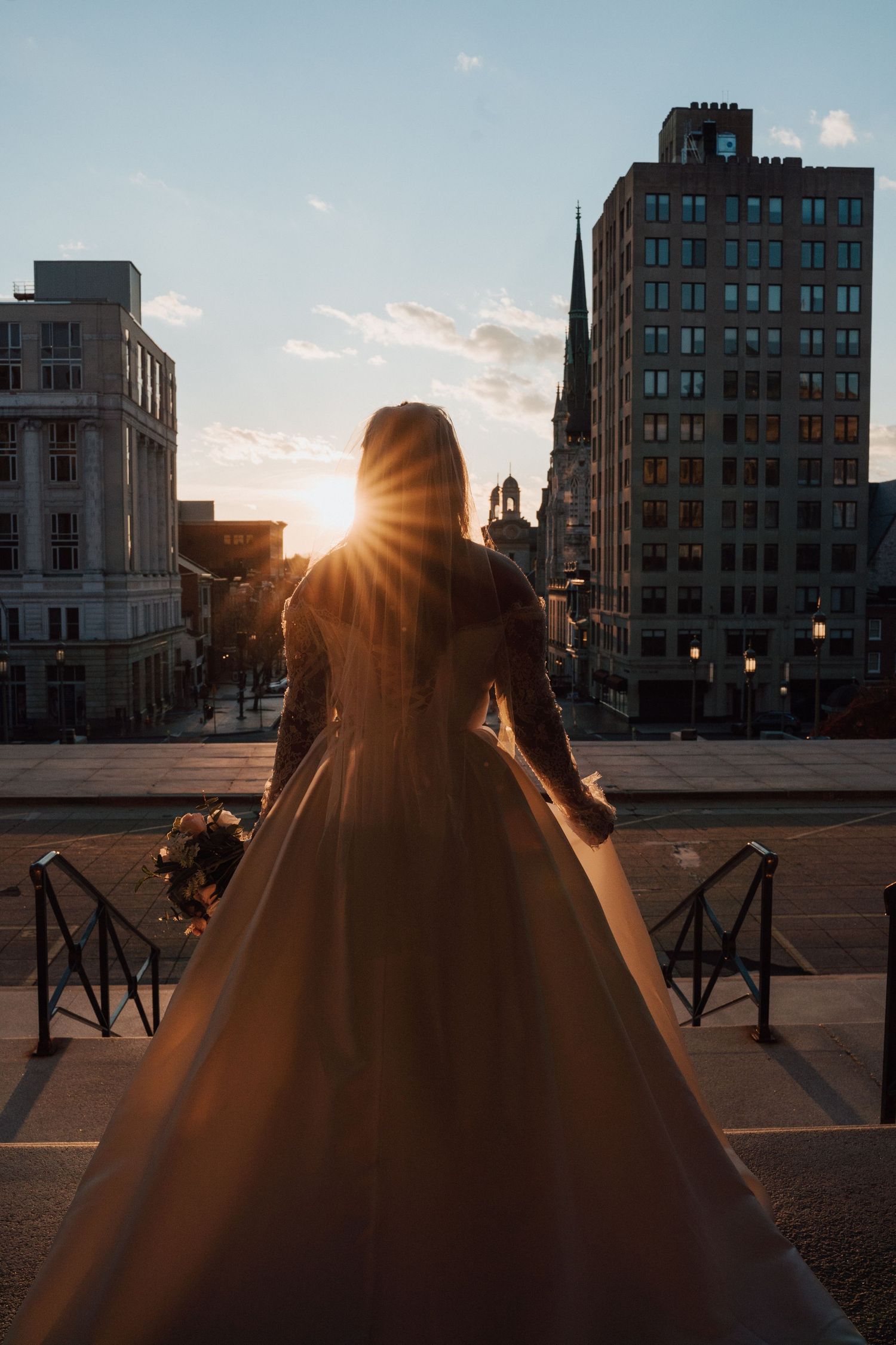 Bridal portrait looking at the sunset in front of the Harrisburg Capitol Building in Harrisburg PA