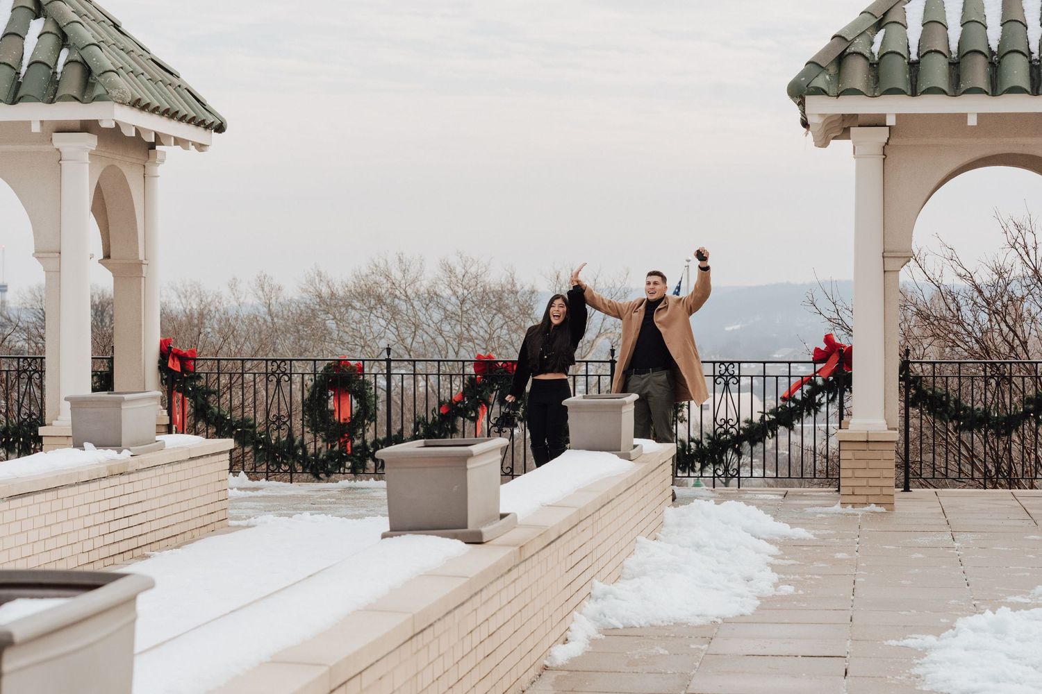 Engaged couples celebrates after engagement proposal at the Hotel Hershey in Hershey PA at engagement proposal photoshoot.