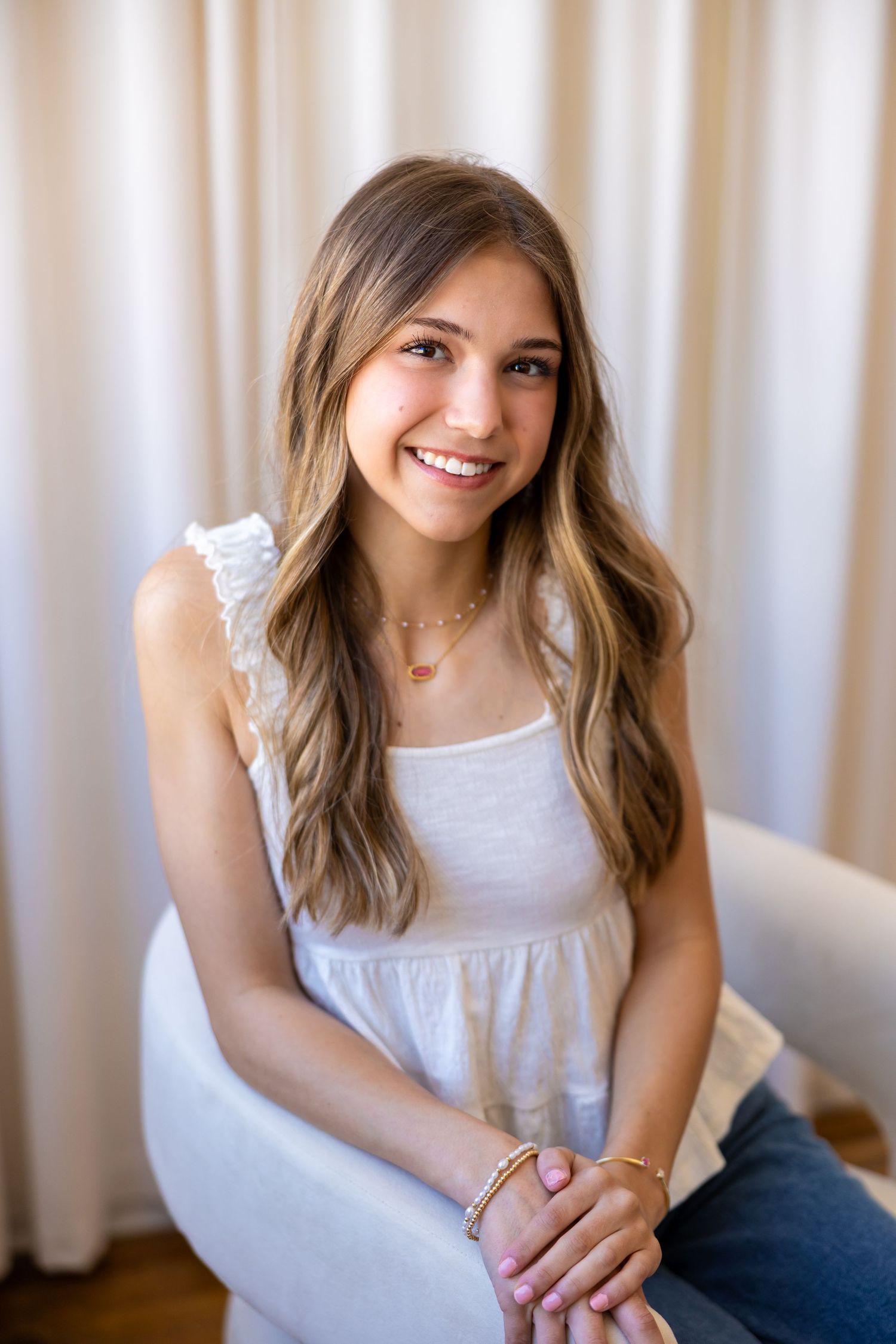 A lifestyle portrait series shows a woman in a white tank top and jeans sitting against a light background.