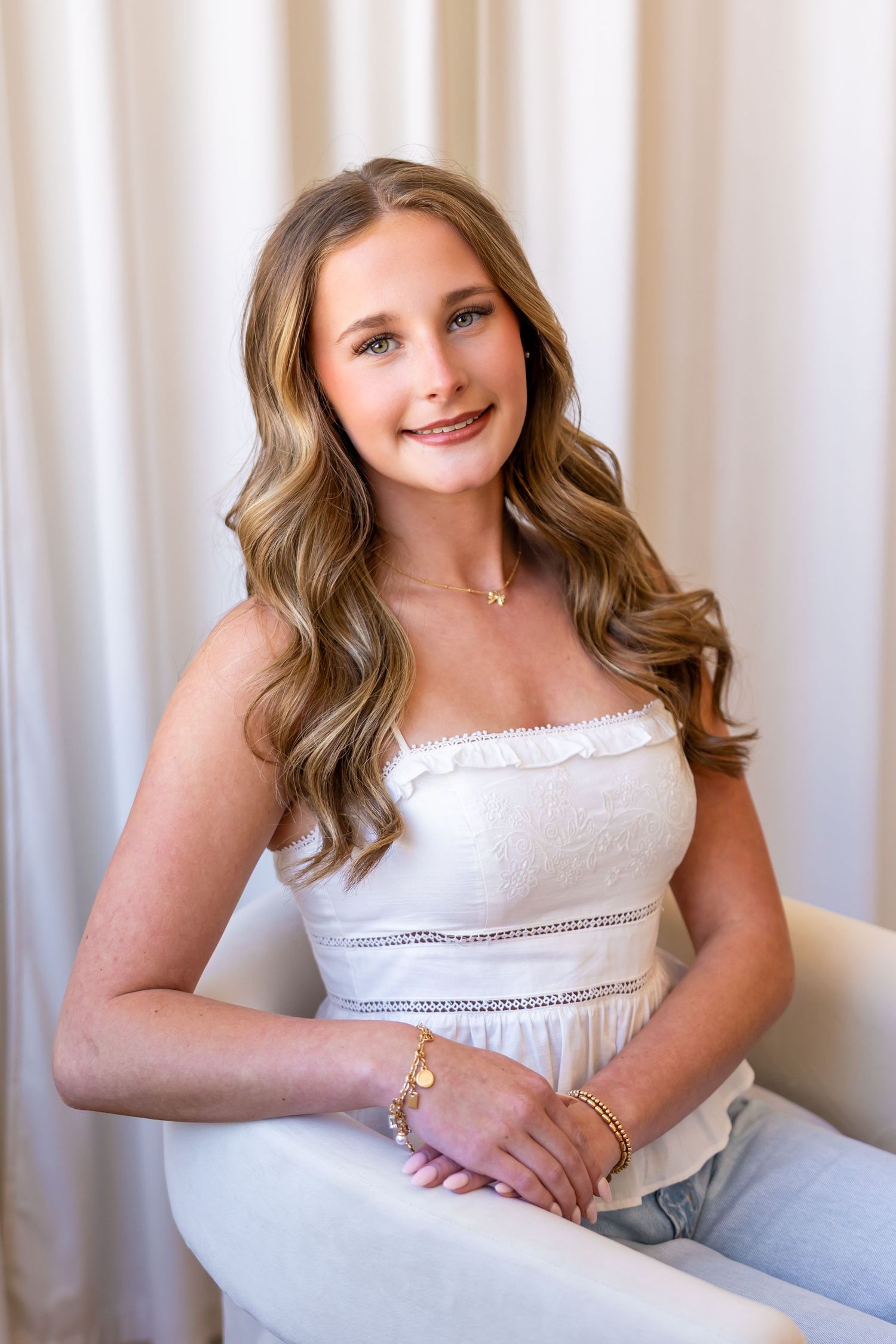 A series of five professional portrait photos showing someone in a white top against a light background.