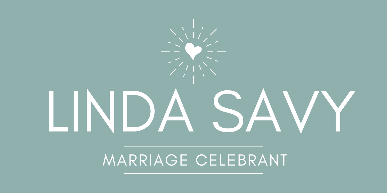 A teal business logo for Linda Savy Marriage Celebrant featuring a small decorative heart starburst design.