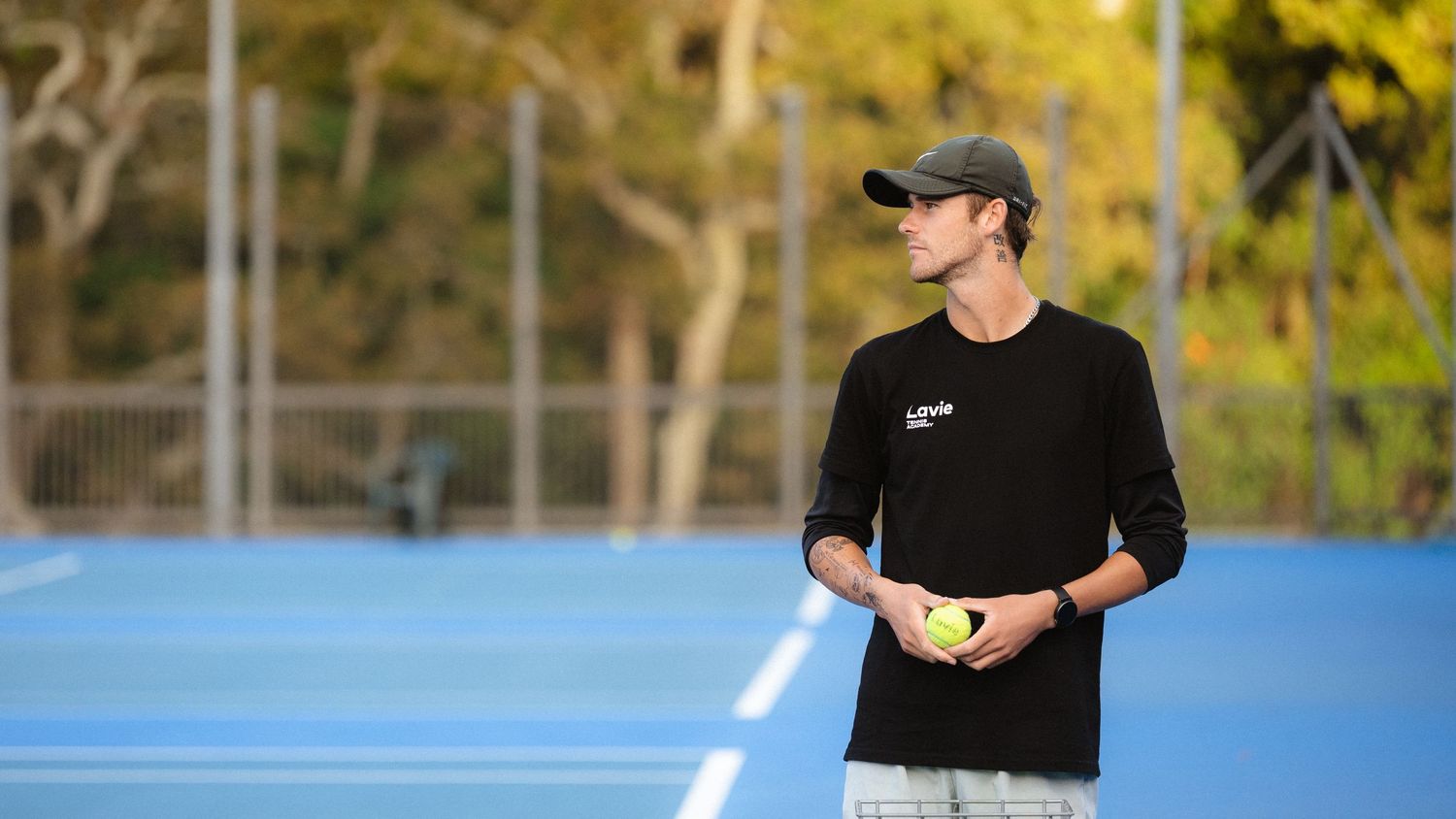 Athletes training outdoors on a sunny day wearing athletic gear.