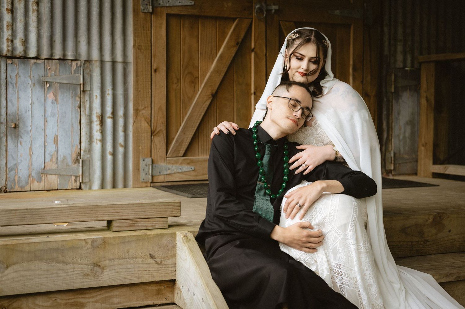Intimate wedding photos captured in a rustic barn setting with wooden walls and natural light.