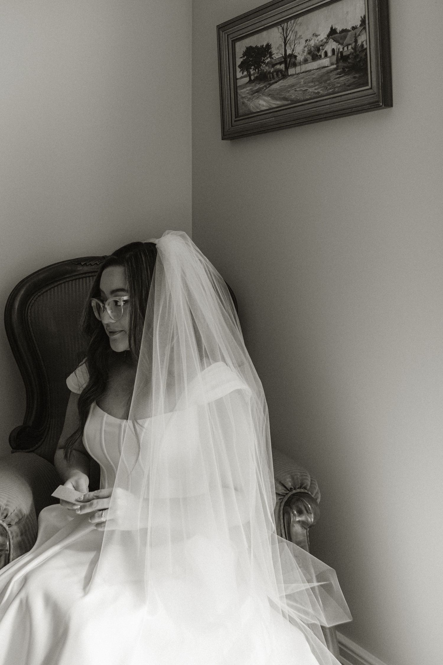 Bride sitting on a vintage couch moments before she gets married.