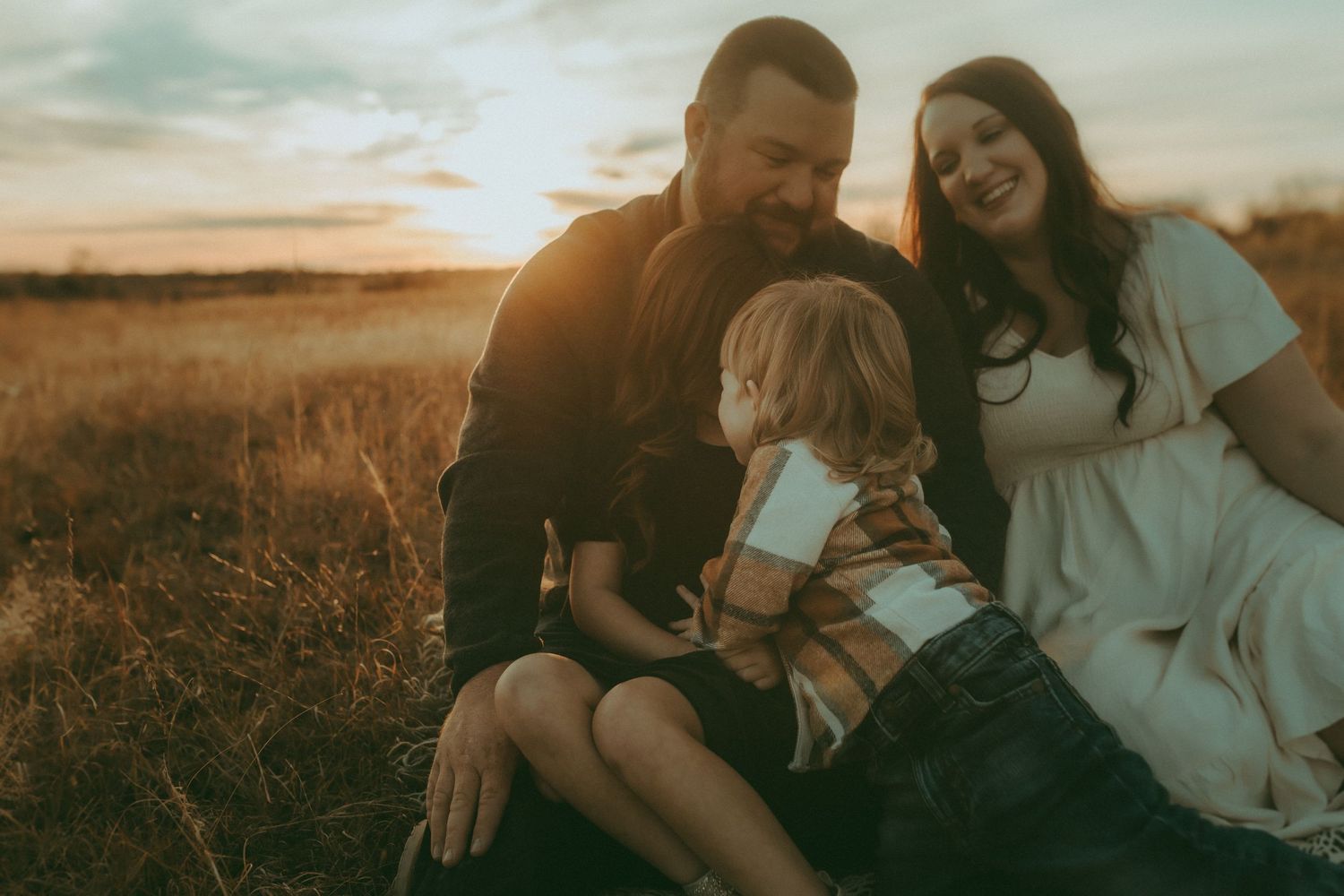 Mother and daughters snuggled together – lifestyle motherhood photographer in Kansas