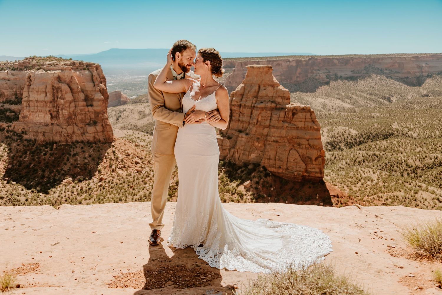 A romantic wedding photo captured on the edge of a majestic red rock canyon.