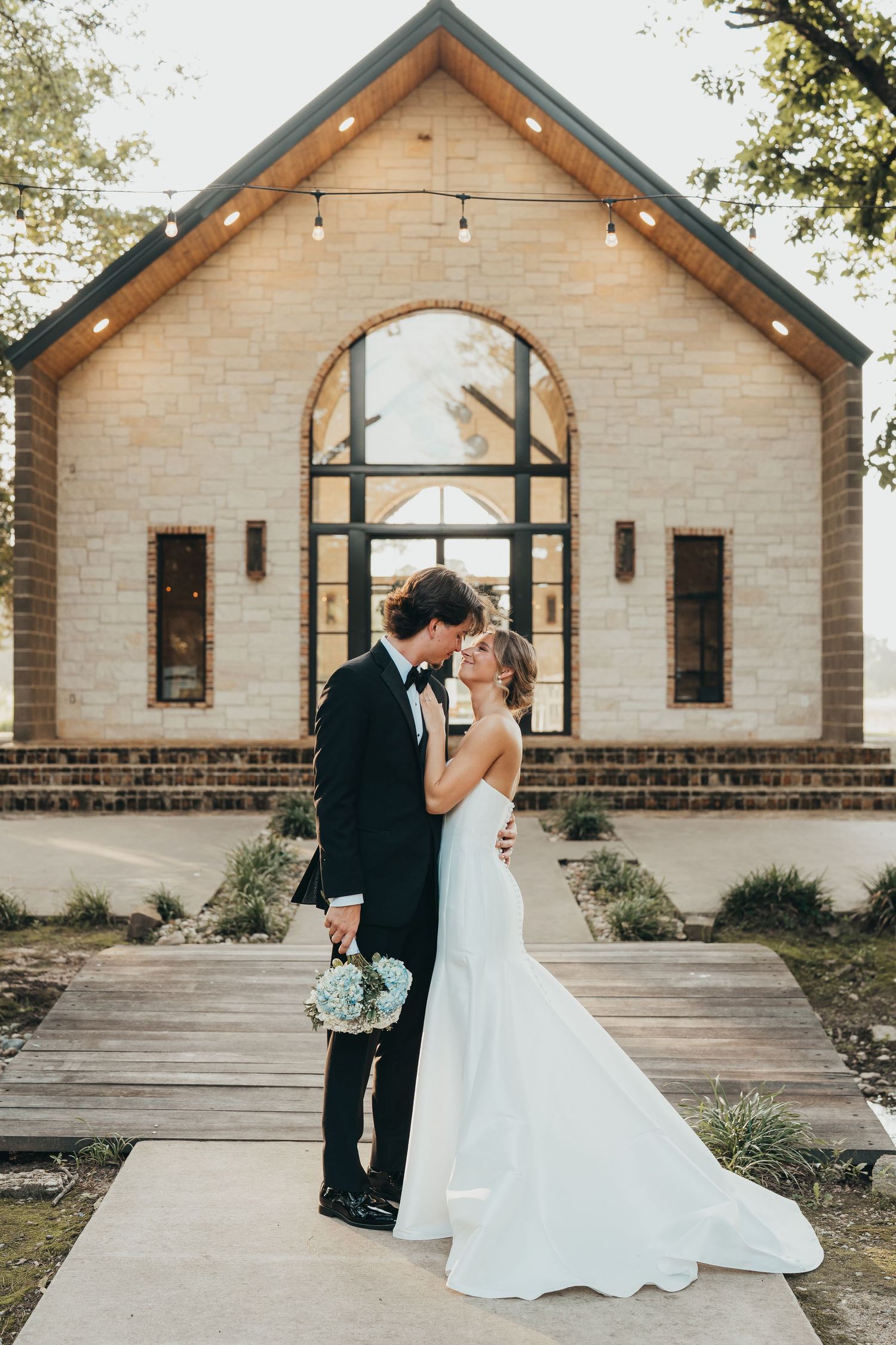 Newlywed couple standing outside their wedding chapel | East Texas wedding photographer