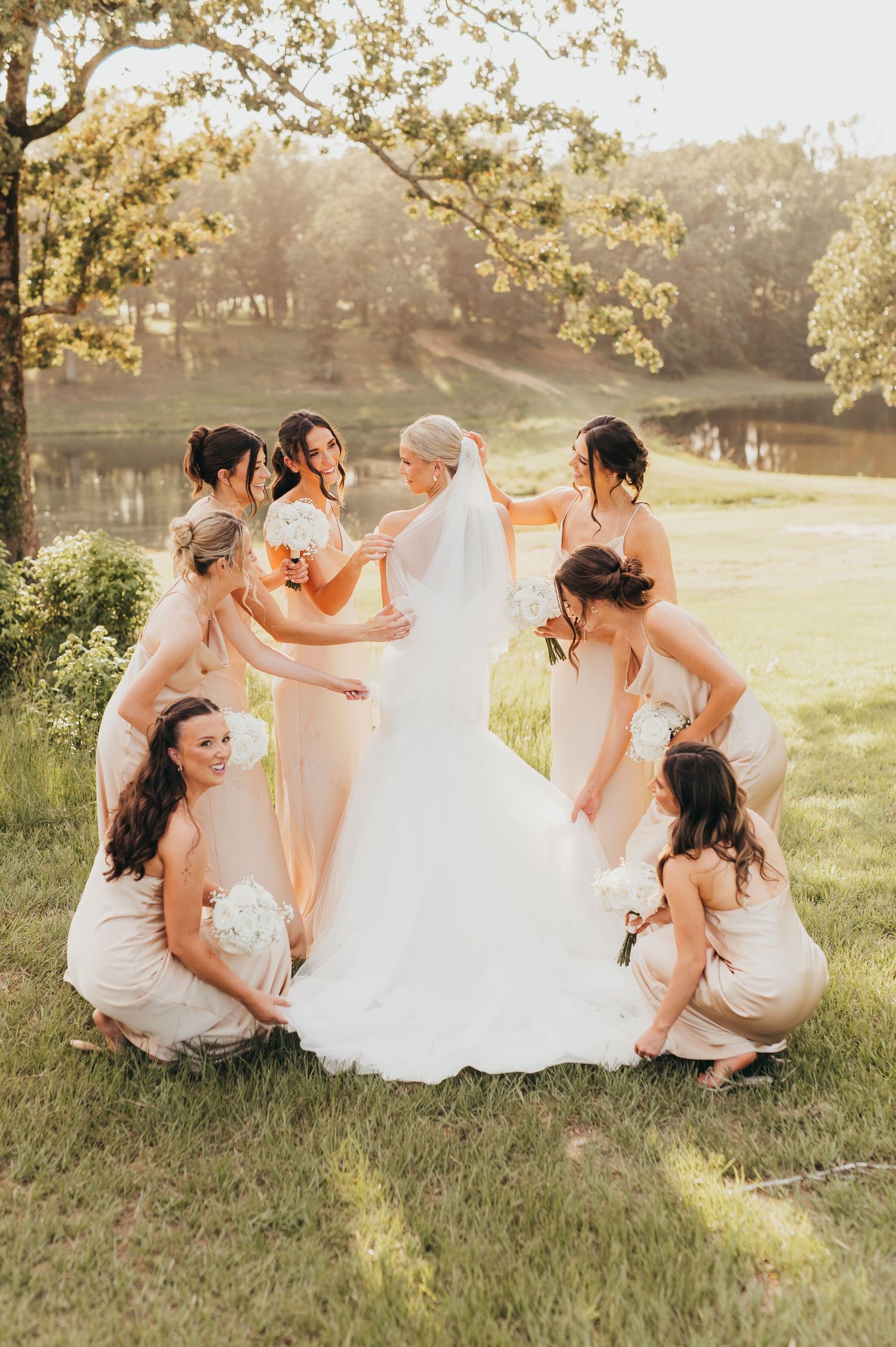 Bride posing with her bridesmaids outdoors on her wedding day | East Texas wedding photographer