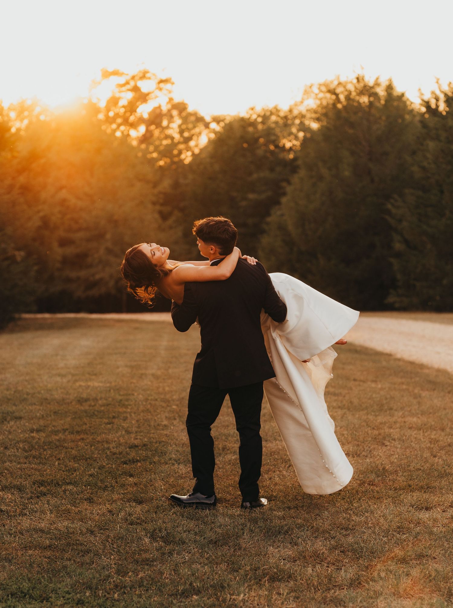 Bride and groom celebrating together during sunset on their wedding day | East Texas wedding photographer