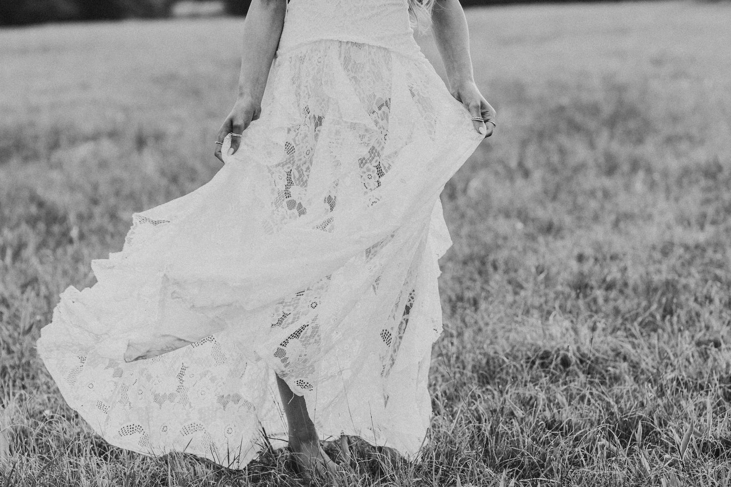 Close up black and white senior portrait of a seniors girl dress flowing in an outdoor setting.