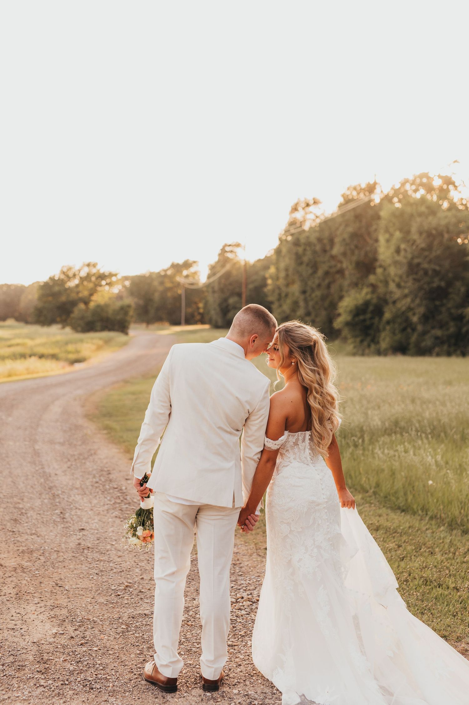 Bride and groom walking outdoors on their wedding day | East Texas wedding photographer