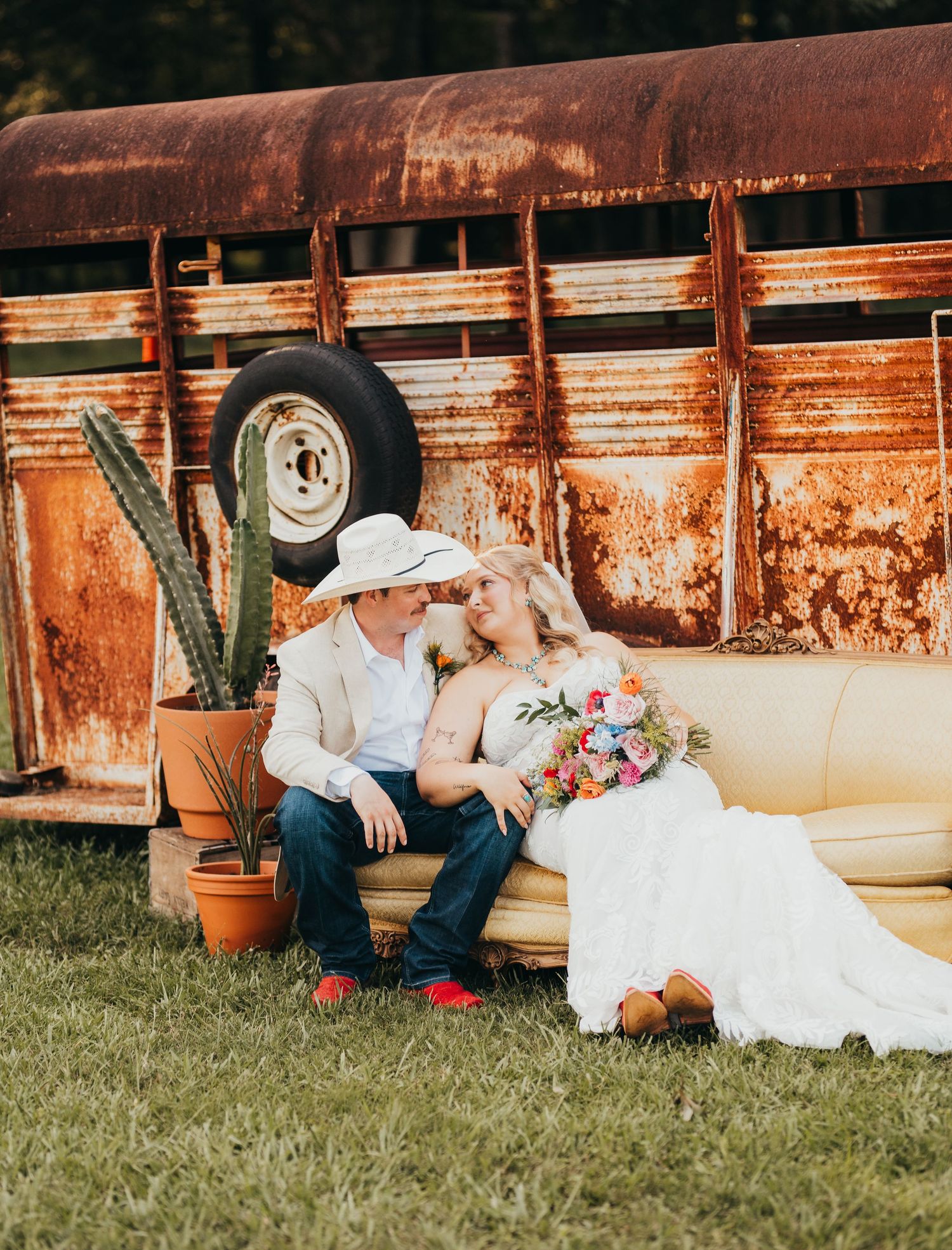 Bride and groom sitting together outdoors on their wedding day | East Texas wedding photographer