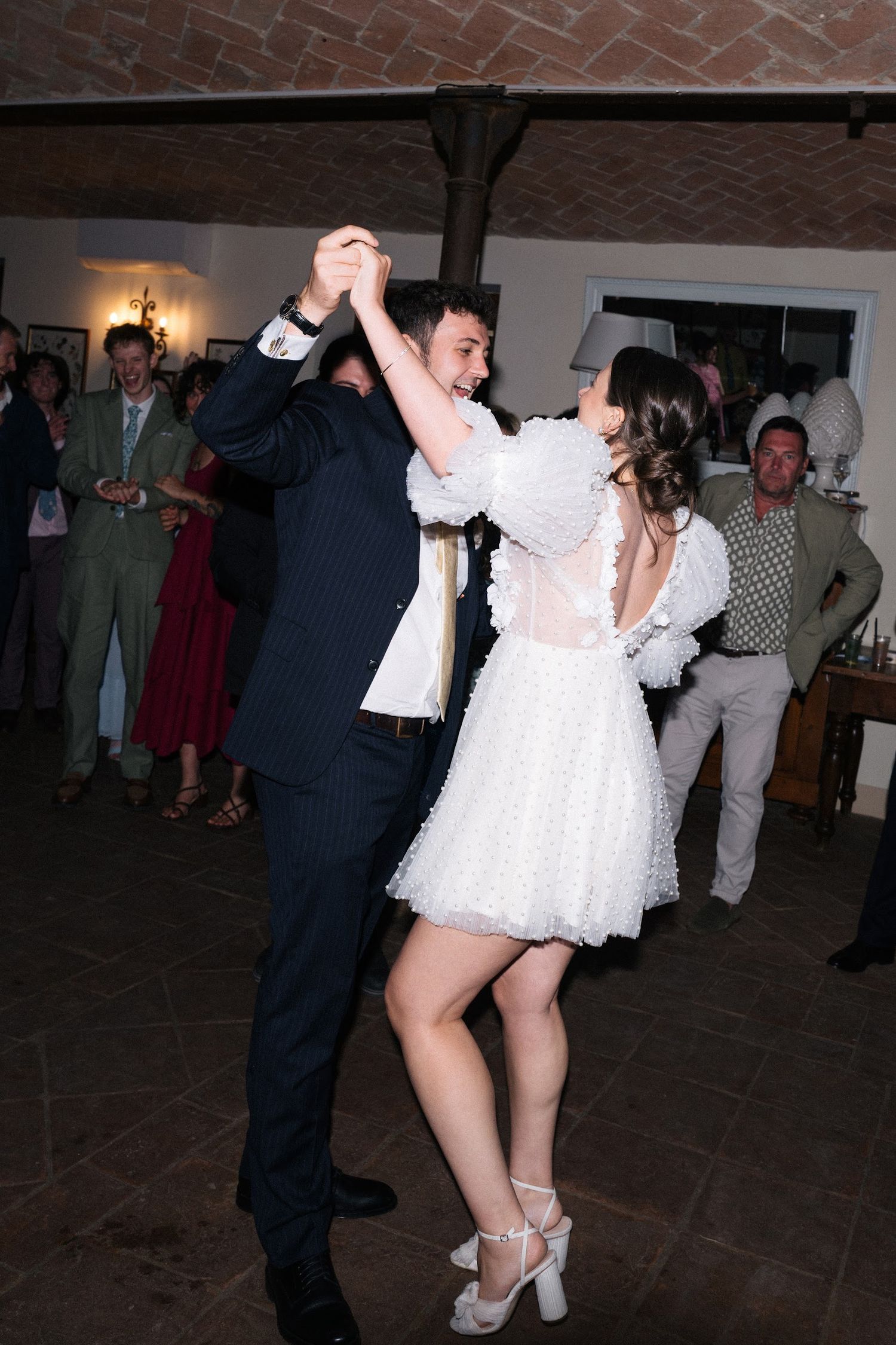 Bride and groom dancing together at elegant wedding reception venue.