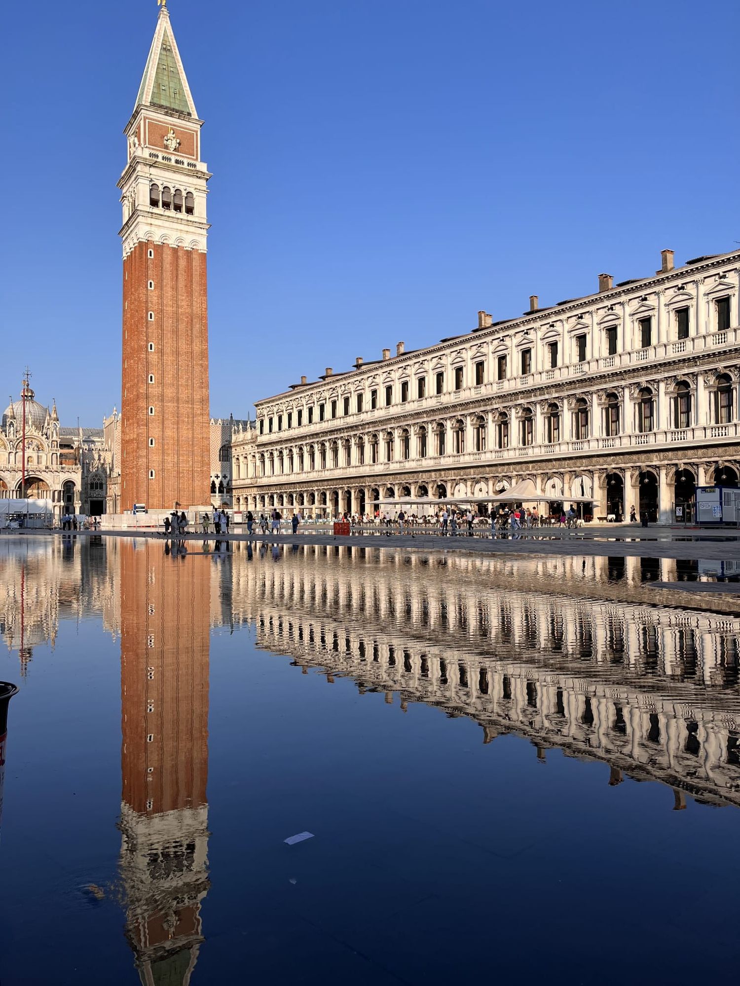 St Marks Campanile bell tower reflecting in flooded Piazza San Marco Venice Italy.