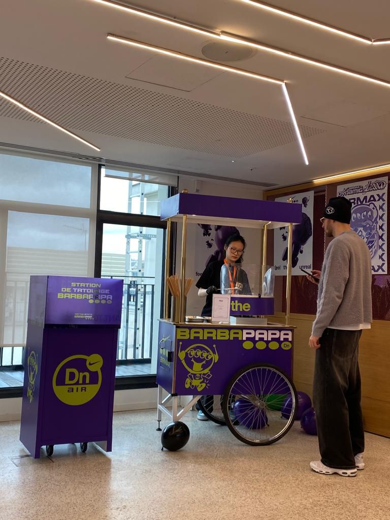 Purple Barba Papa food cart with vendor serving customer in modern indoor space.
