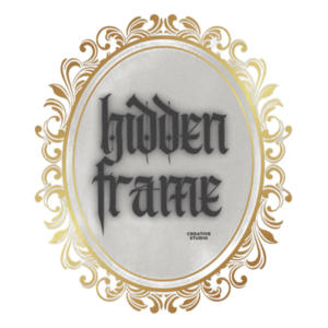 Hidden Frame Creative Studio logo with gothic lettering inside an ornate gold oval frame on white background.