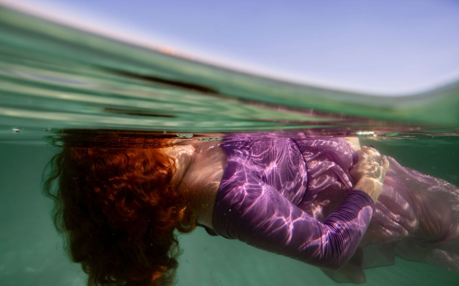 Cinematic underwater photo, in a documentary style, magical underwater photoshoot. Destination Elopement, maternity underwater photographer