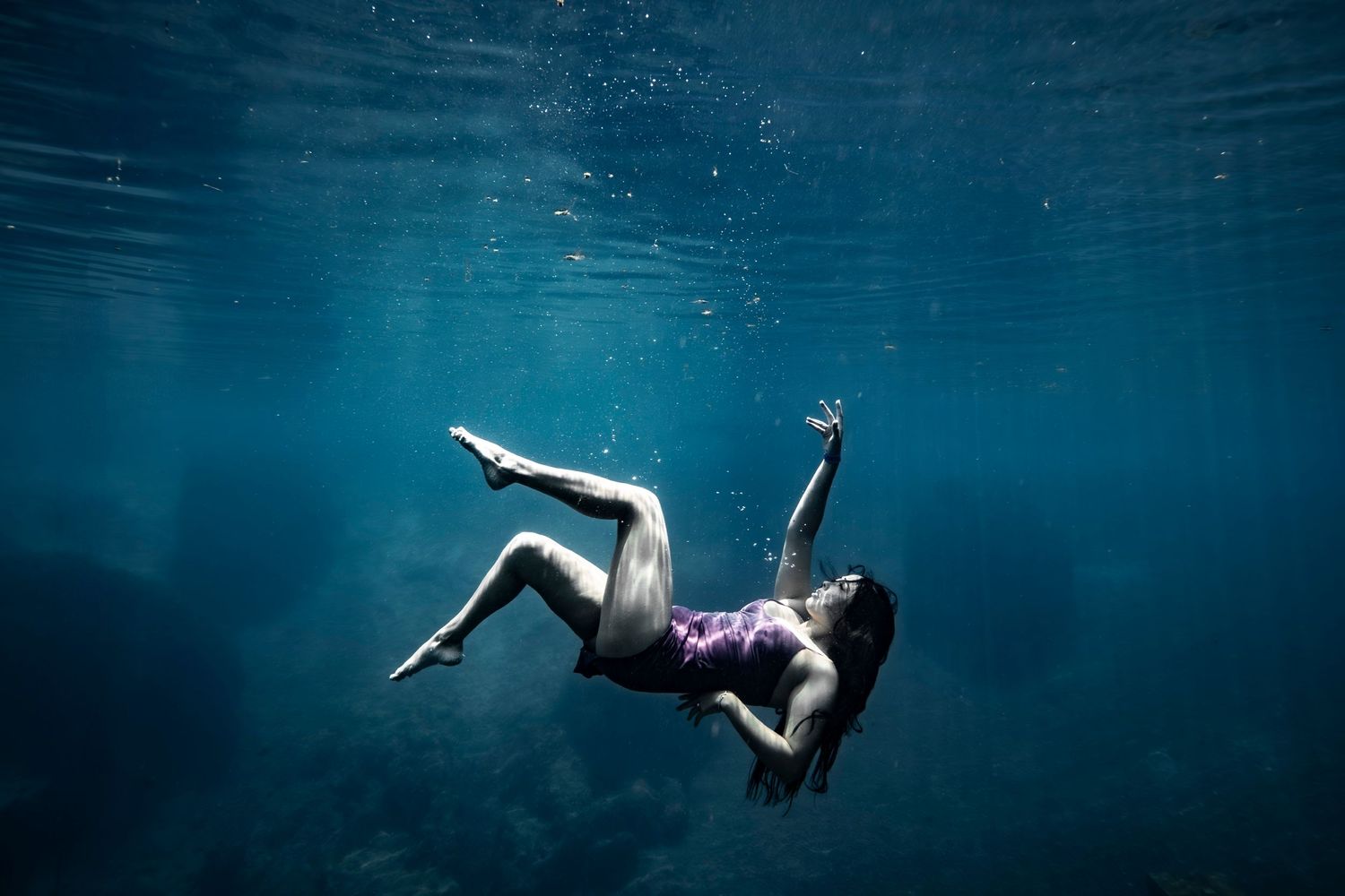Cinematic underwater photo, in a documentary style, magical underwater photoshoot. Destination Elopement, maternity underwater photographer