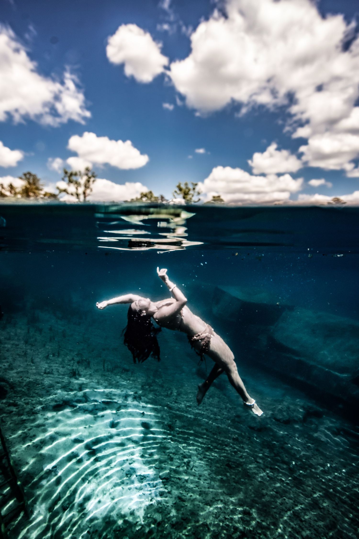 Cinematic underwater photo, in a documentary style, magical underwater photoshoot. Destination Elopement, maternity underwater photographer