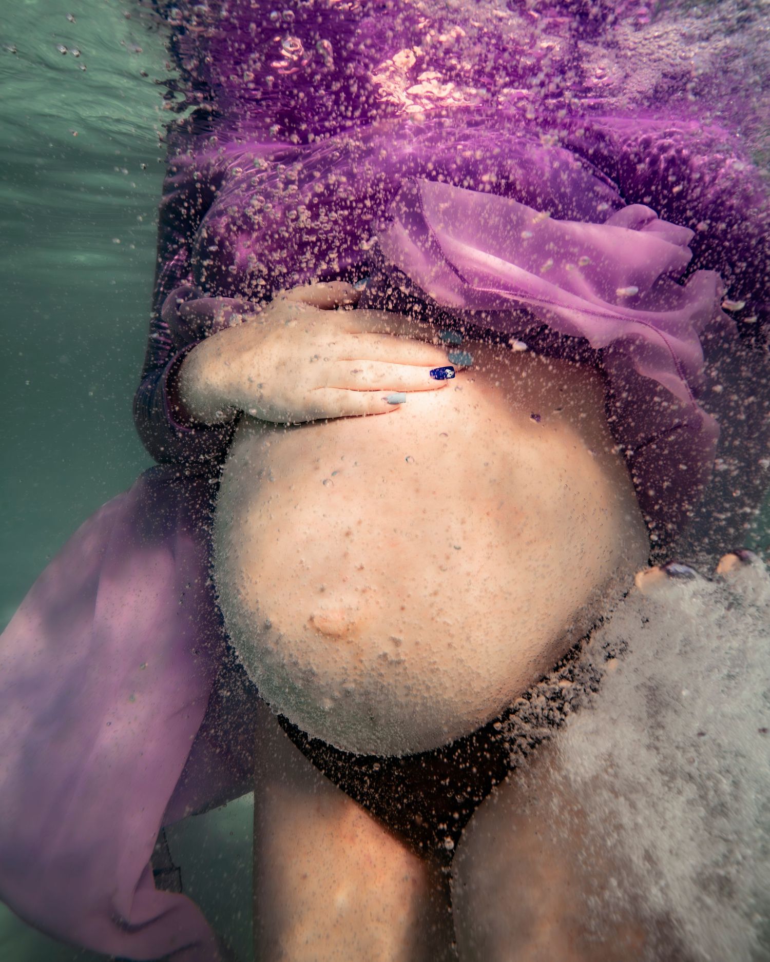 Cinematic underwater photo, in a documentary style, magical underwater photoshoot. Destination Elopement, maternity underwater photographer