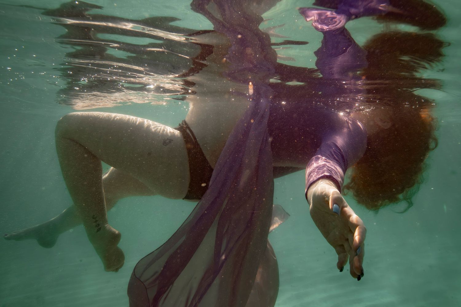 Cinematic underwater photo, in a documentary style, magical underwater photoshoot. Destination Elopement, maternity underwater photographer