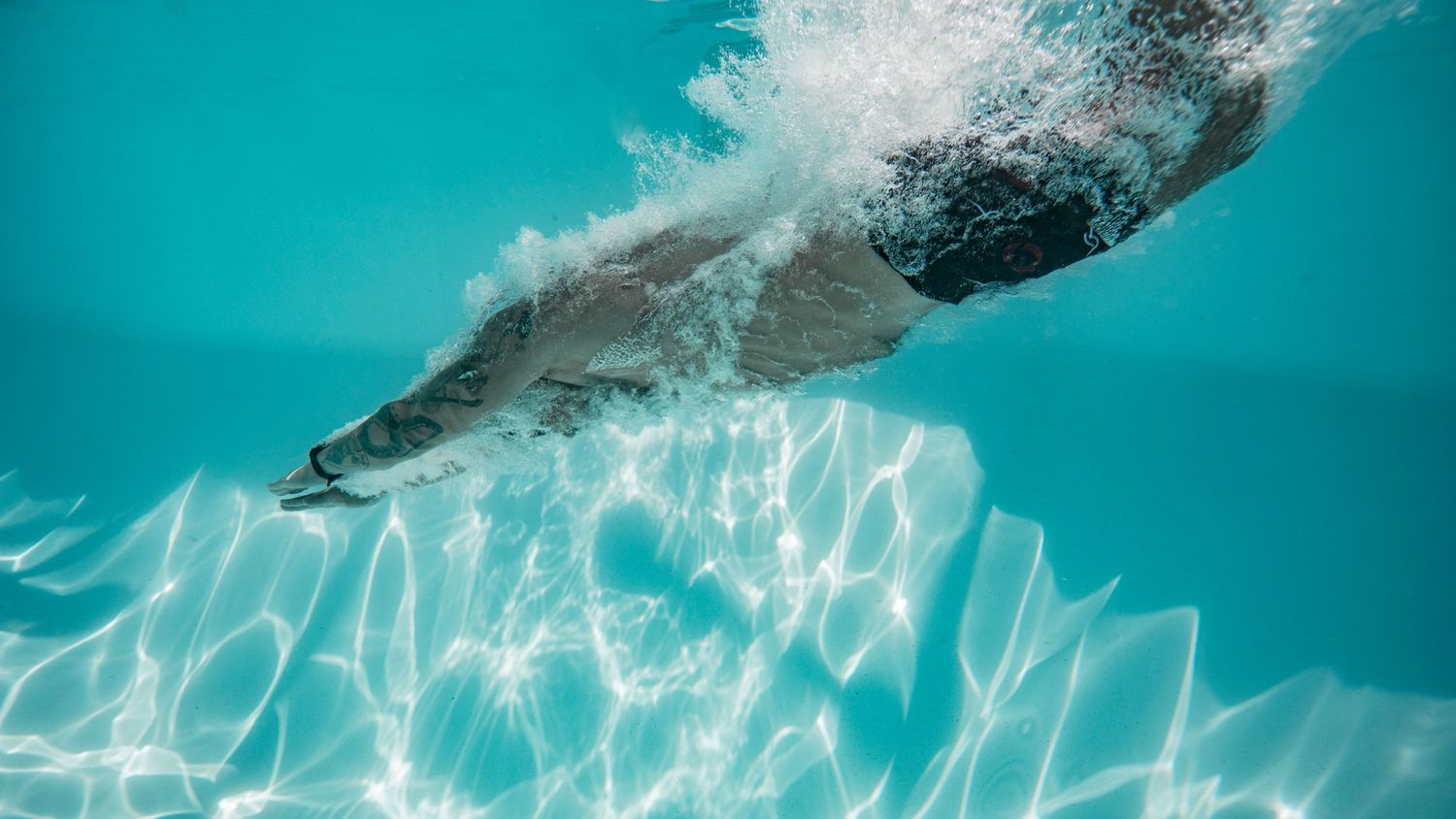 Cinematic underwater photo, in a documentary style, magical underwater photoshoot. Destination Elopement, maternity underwater photographer