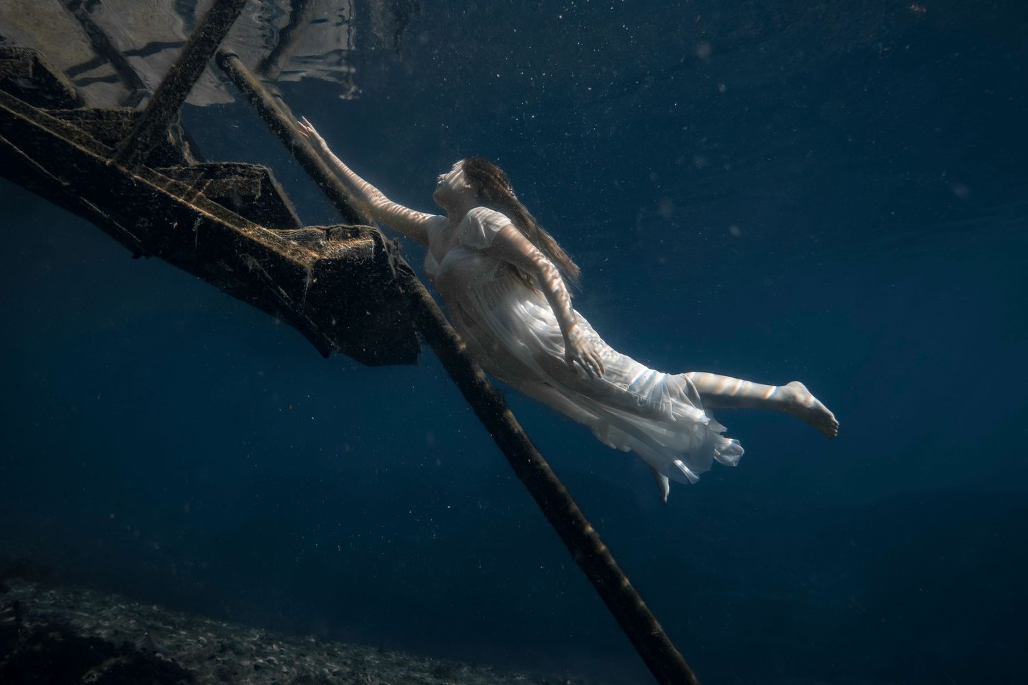 Cinematic underwater photo, in a documentary style, magical underwater photoshoot. Destination Elopement, maternity underwater photographer